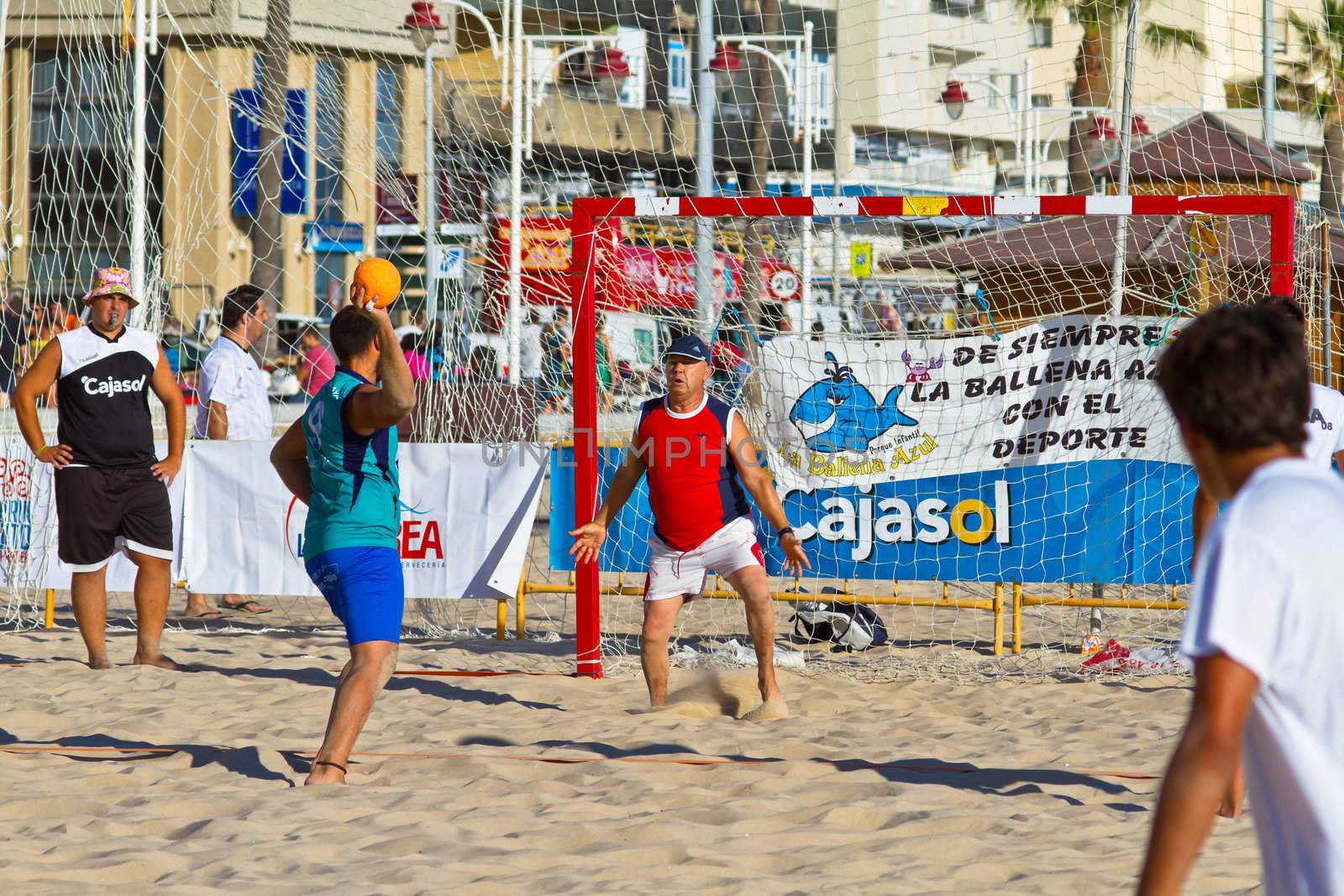 CADIZ, SPAIN - JULY 19: Unidentified players compete in a match between BMPY LAM Chiclana and Los Legendarios in the 19th league of beach handball of Cadiz on July 19, 2011 in Cadiz, Spain