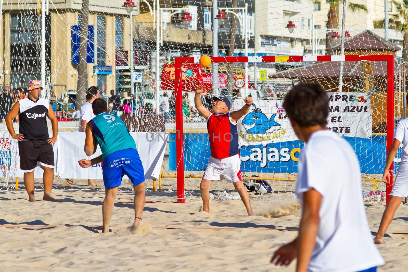 CADIZ, SPAIN - JULY 19: Unidentified players compete in a match between BMPY LAM Chiclana and Los Legendarios in the 19th league of beach handball of Cadiz on July 19, 2011 in Cadiz, Spain