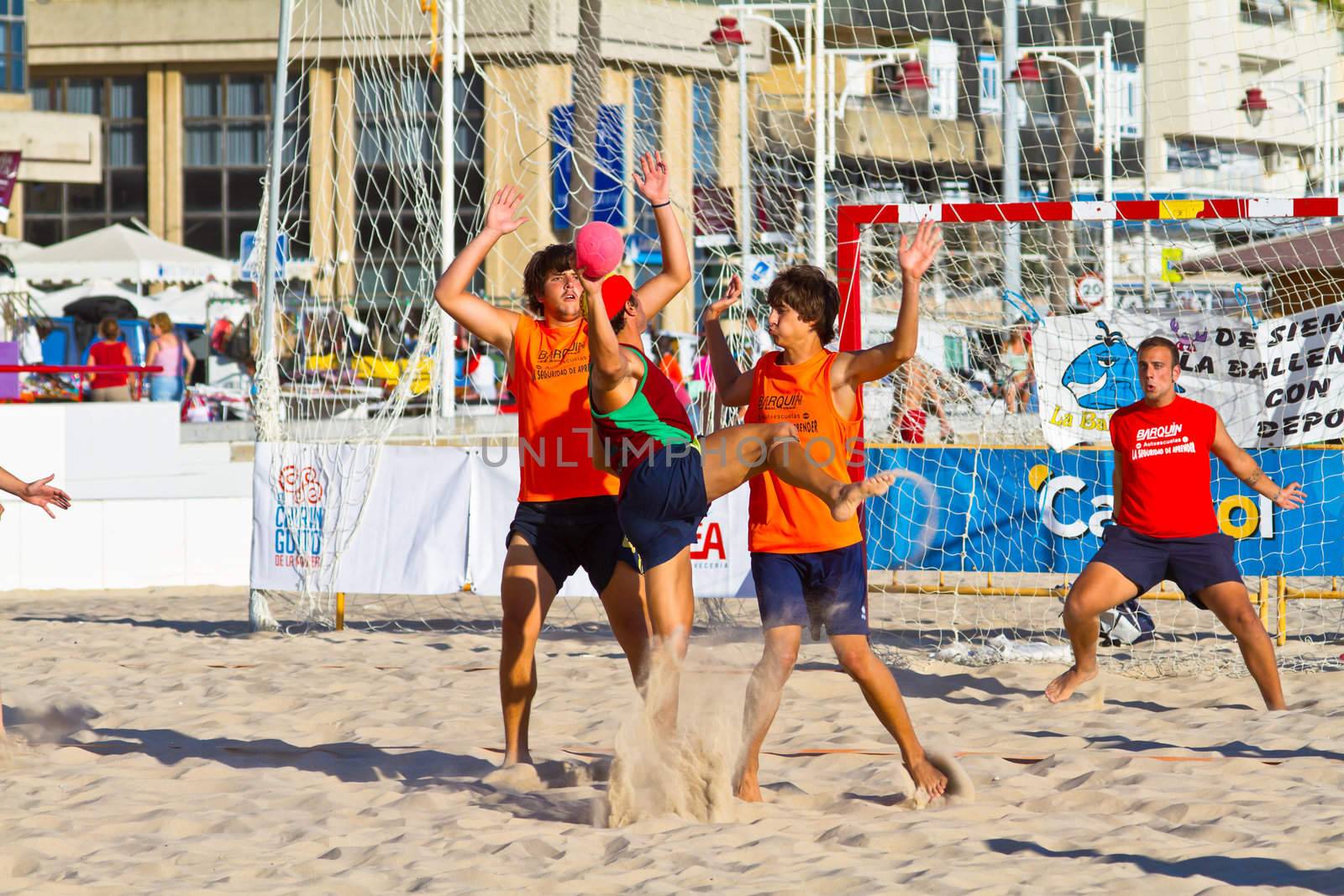 CADIZ, SPAIN - JULY 19: Unidentified players compete in a match between Los Negritos and Autoescuela Barquin in the 19th league of beach handball of Cadiz on July 19, 2011 in Cadiz, Spain