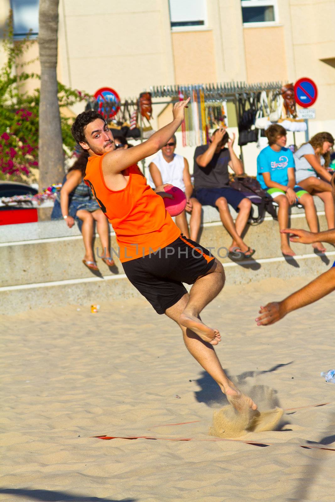 CADIZ, SPAIN - JULY 19: Unidentified players compete in a match between Los Negritos and Autoescuela Barquin in the 19th league of beach handball of Cadiz on July 19, 2011 in Cadiz, Spain