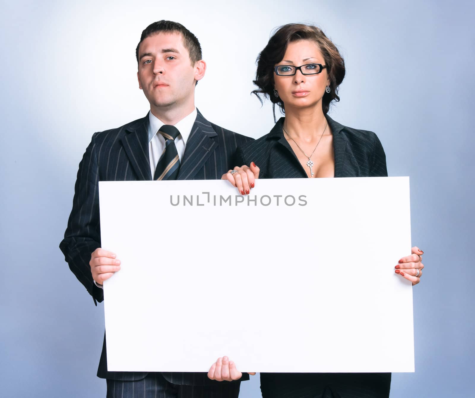 Portrait of business man and business woman holding an empty billboard