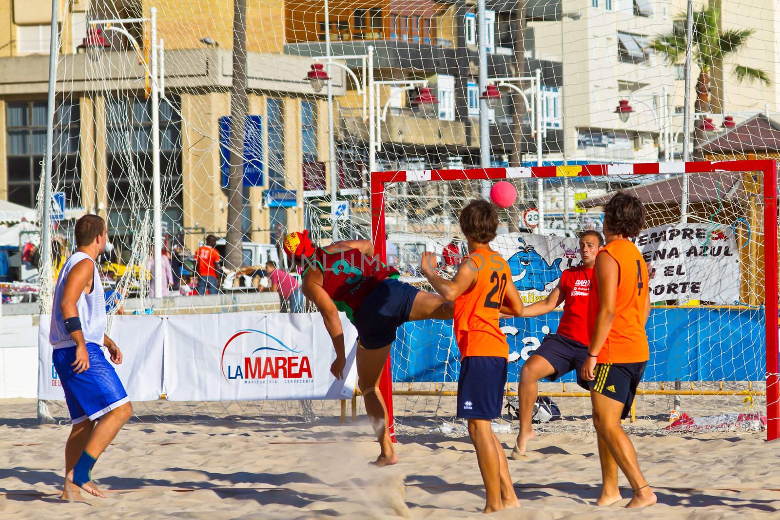 CADIZ, SPAIN - JULY 19: Unidentified players compete in a match between Los Negritos and Autoescuela Barquin in the 19th league of beach handball of Cadiz on July 19, 2011 in Cadiz, Spain
