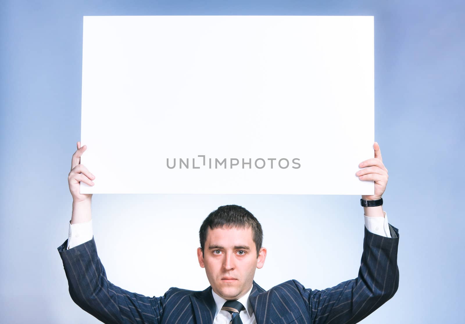 Portrait of business man holding an empty billboard