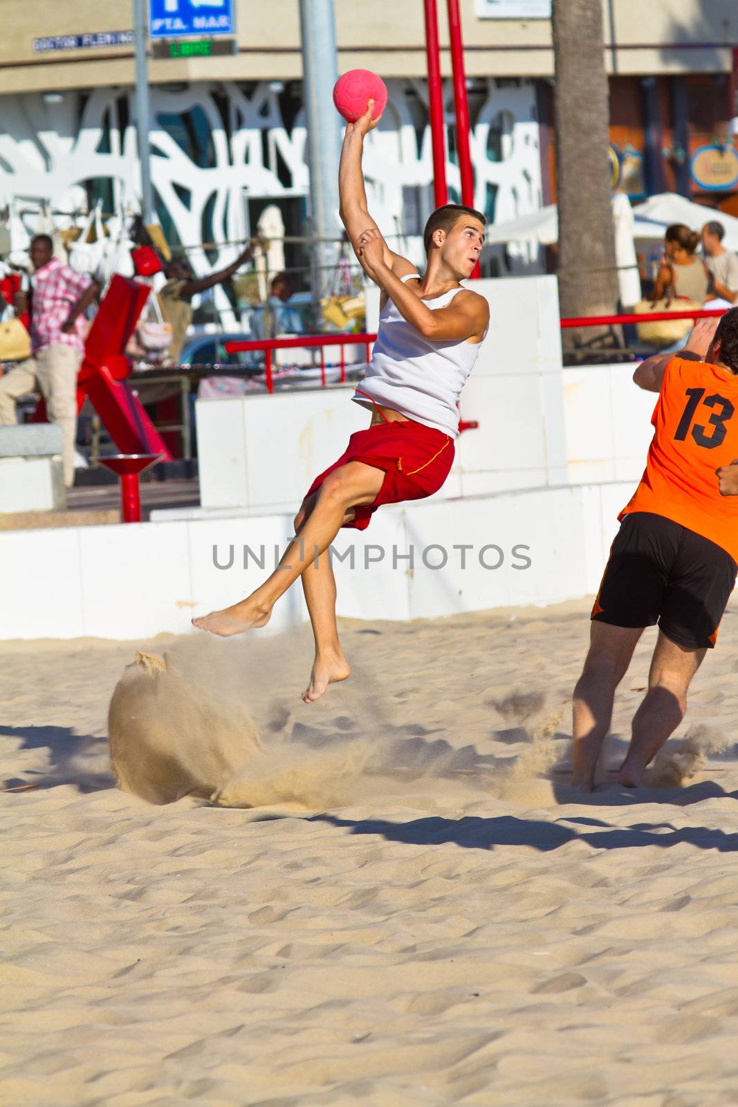 CADIZ, SPAIN - JULY 19: Unidentified players compete in a match between Los Negritos and Autoescuela Barquin in the 19th league of beach handball of Cadiz on July 19, 2011 in Cadiz, Spain