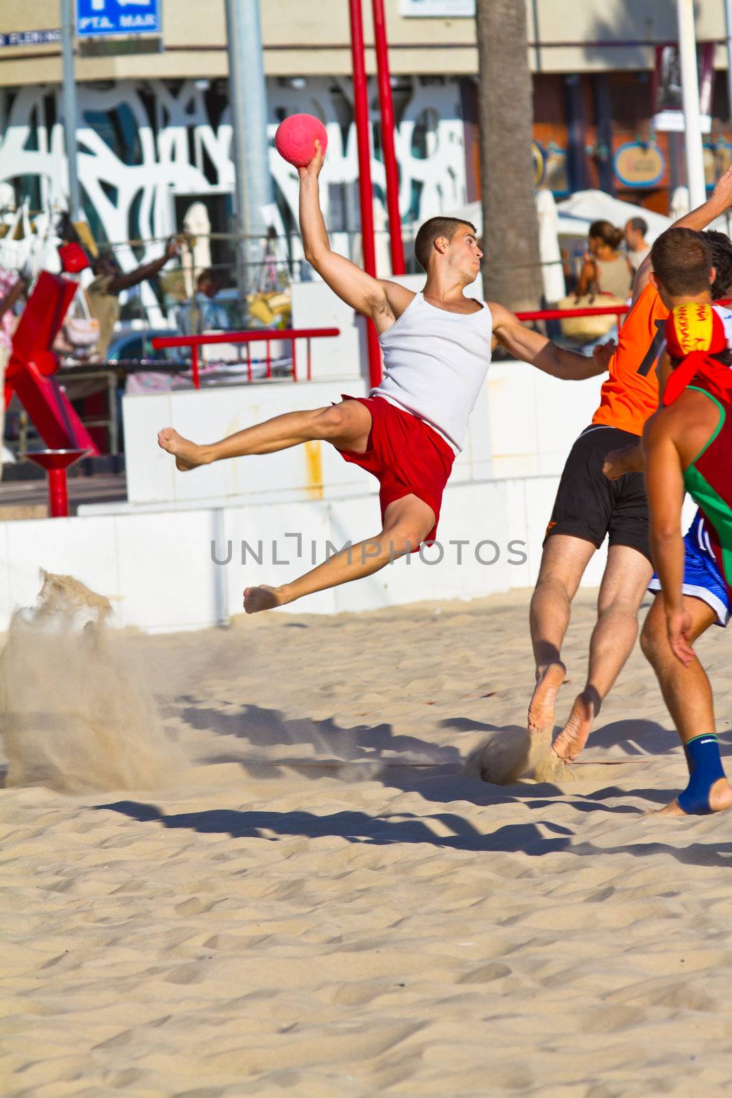 CADIZ, SPAIN - JULY 19: Unidentified players compete in a match between Los Negritos and Autoescuela Barquin in the 19th league of beach handball of Cadiz on July 19, 2011 in Cadiz, Spain