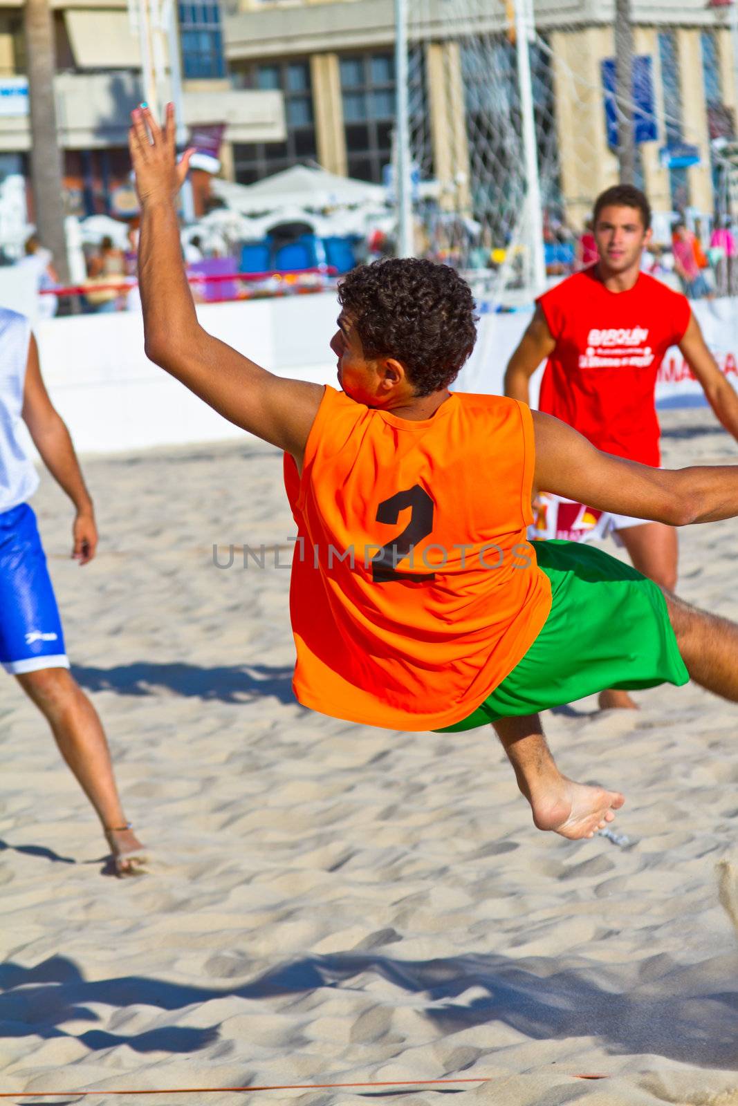 CADIZ, SPAIN - JULY 19: Unidentified players compete in a match between Los Negritos and Autoescuela Barquin in the 19th league of beach handball of Cadiz on July 19, 2011 in Cadiz, Spain