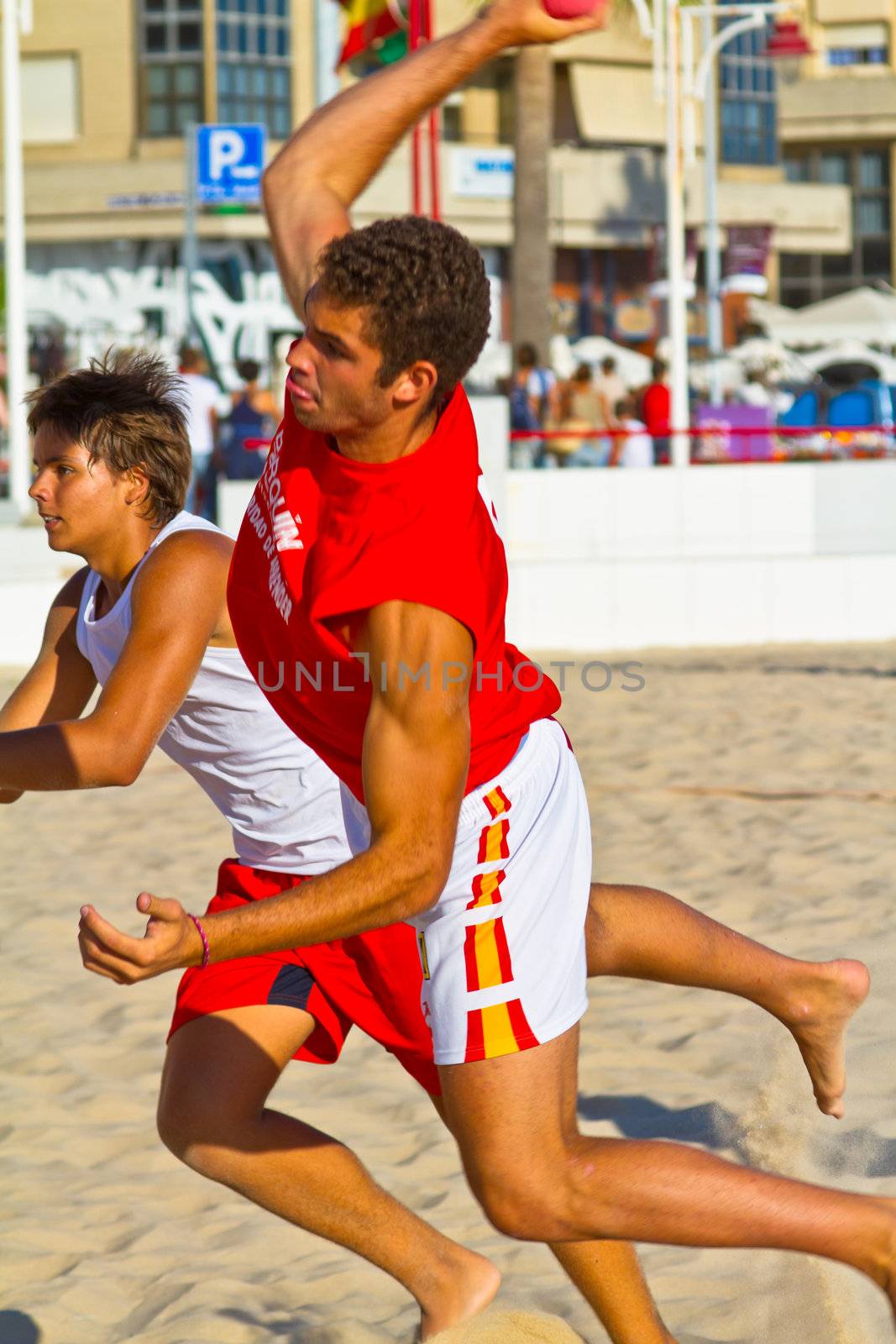 CADIZ, SPAIN - JULY 19: Unidentified players compete in a match between Los Negritos and Autoescuela Barquin in the 19th league of beach handball of Cadiz on July 19, 2011 in Cadiz, Spain
