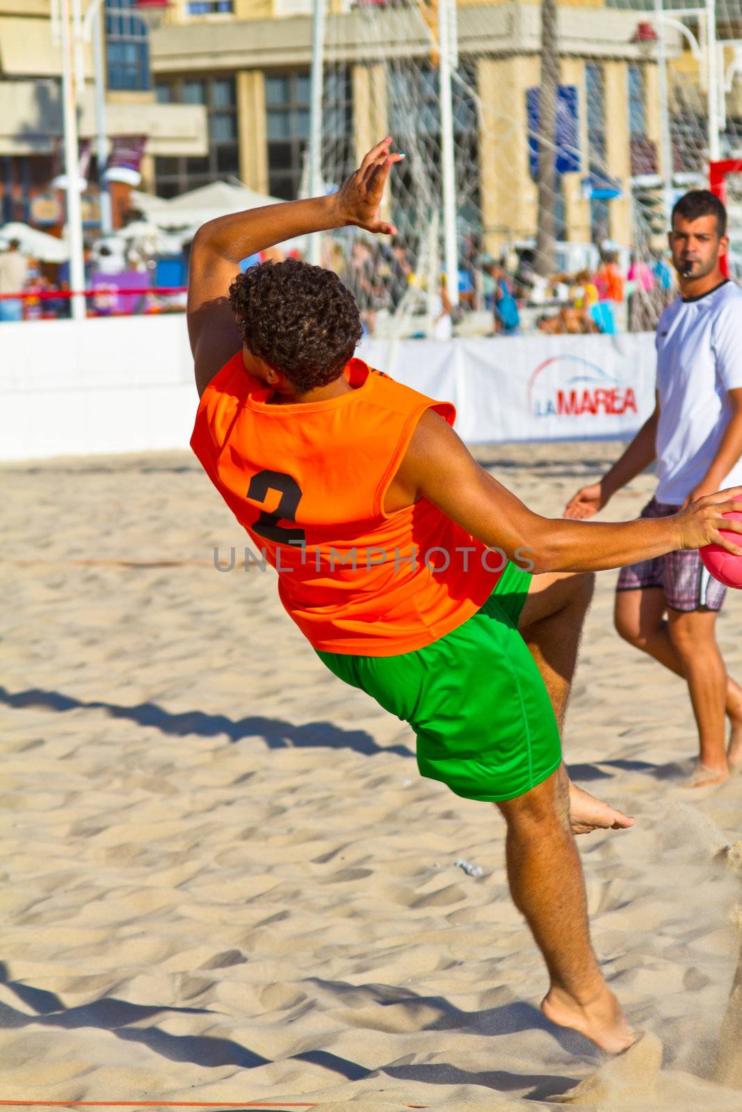 CADIZ, SPAIN - JULY 19: Unidentified players compete in a match between Los Negritos and Autoescuela Barquin in the 19th league of beach handball of Cadiz on July 19, 2011 in Cadiz, Spain