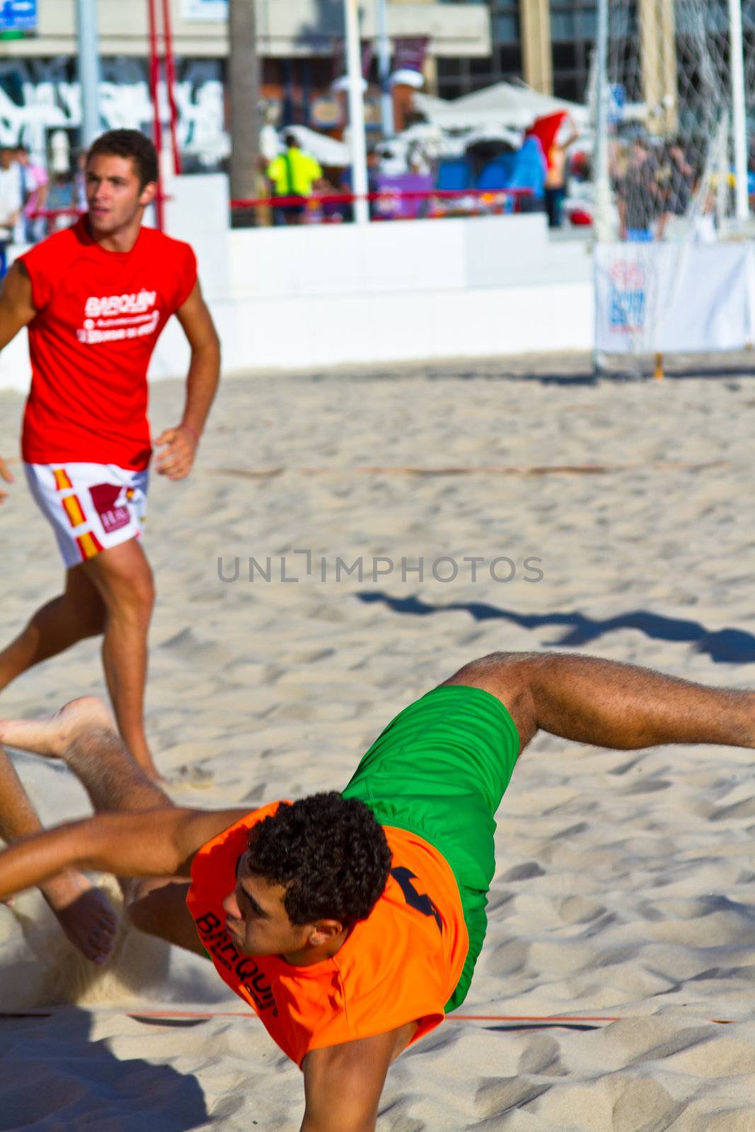 CADIZ, SPAIN - JULY 19: Unidentified players compete in a match between Los Negritos and Autoescuela Barquin in the 19th league of beach handball of Cadiz on July 19, 2011 in Cadiz, Spain