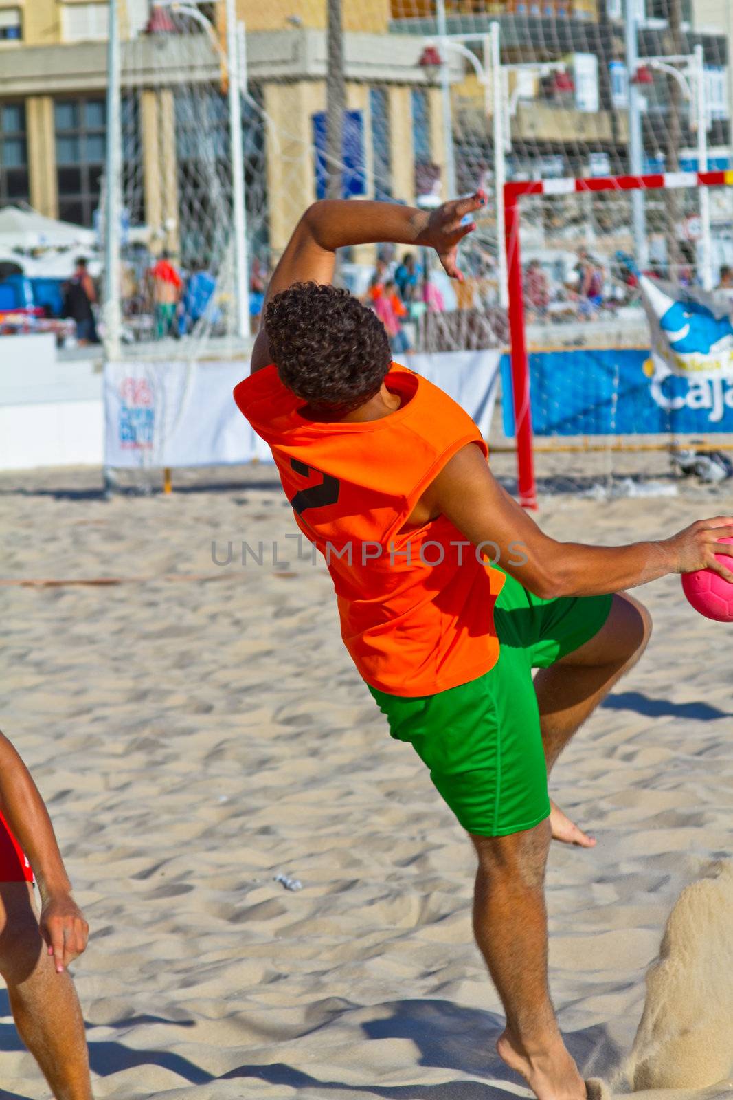 CADIZ, SPAIN - JULY 19: Unidentified players compete in a match between Los Negritos and Autoescuela Barquin in the 19th league of beach handball of Cadiz on July 19, 2011 in Cadiz, Spain