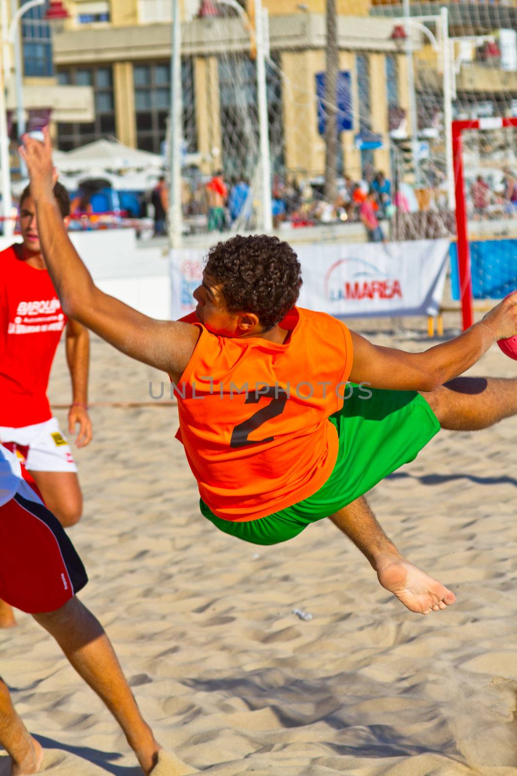 CADIZ, SPAIN - JULY 19: Unidentified players compete in a match between Los Negritos and Autoescuela Barquin in the 19th league of beach handball of Cadiz on July 19, 2011 in Cadiz, Spain