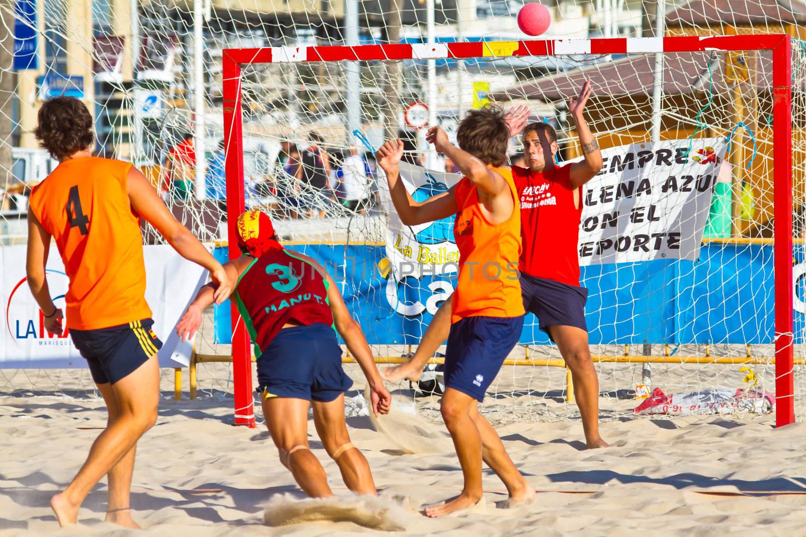 CADIZ, SPAIN - JULY 19: Unidentified players compete in a match between Los Negritos and Autoescuela Barquin in the 19th league of beach handball of Cadiz on July 19, 2011 in Cadiz, Spain