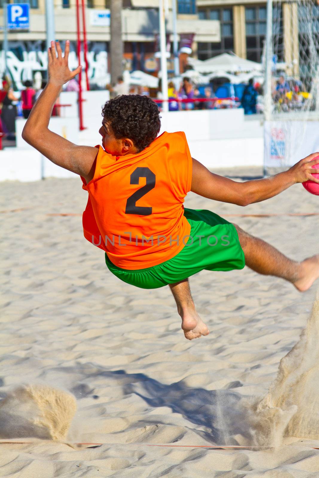 CADIZ, SPAIN - JULY 19: Unidentified players compete in a match between Los Negritos and Autoescuela Barquin in the 19th league of beach handball of Cadiz on July 19, 2011 in Cadiz, Spain