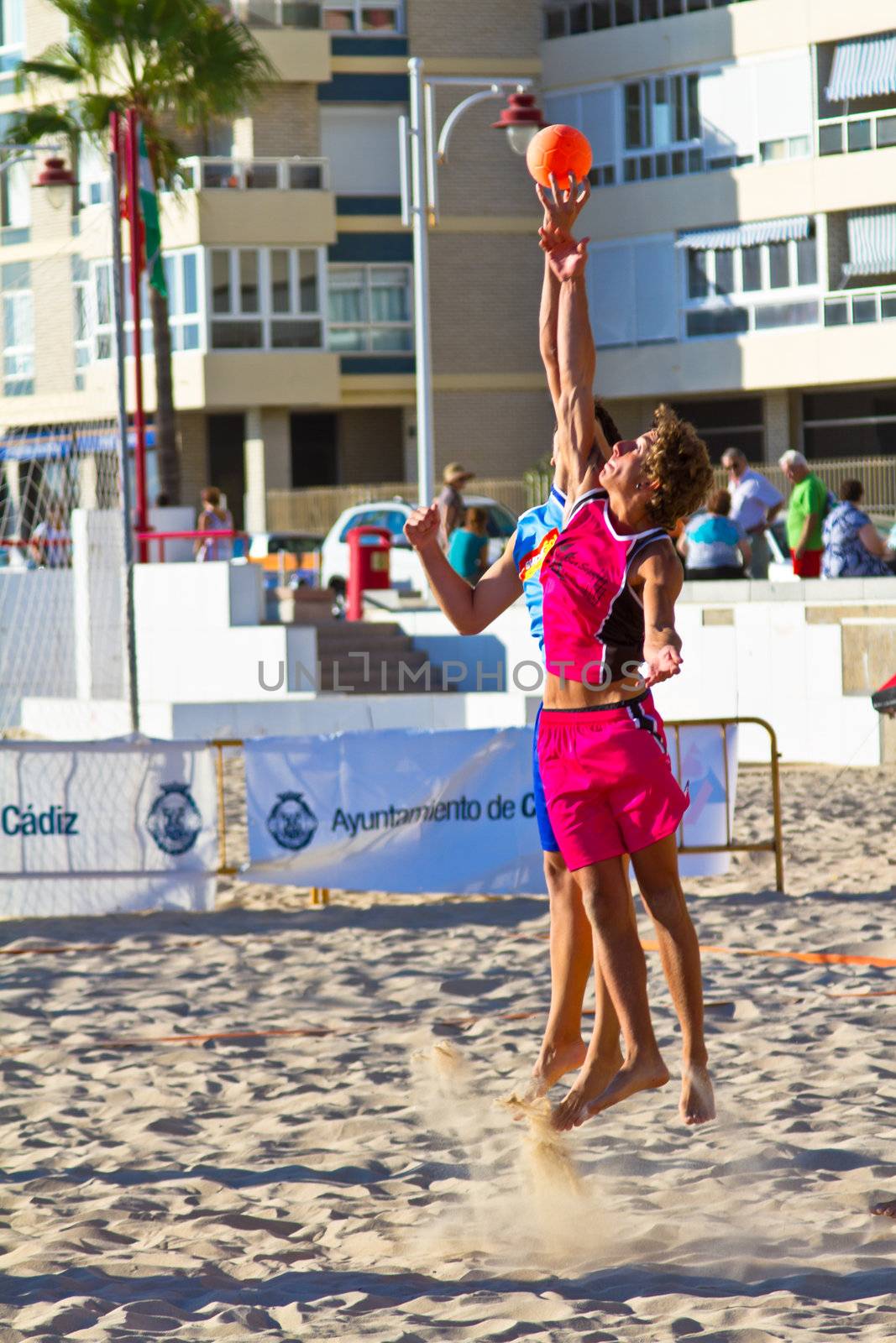 CADIZ, SPAIN - JULY 19: Unidentified players compete in a match between Zonabalonmano.com and CadizSur Seguros BMPY in the 19th league of beach handball of Cadiz on July 19, 2011 in Cadiz, Spain