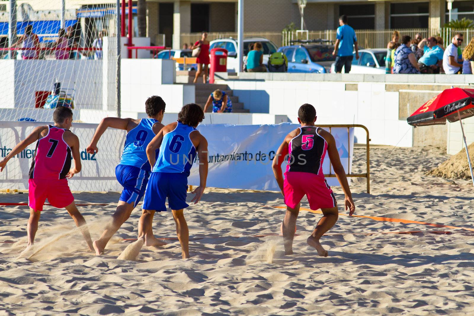 CADIZ, SPAIN - JULY 19: Unidentified players compete in a match between Zonabalonmano.com and CadizSur Seguros BMPY in the 19th league of beach handball of Cadiz on July 19, 2011 in Cadiz, Spain