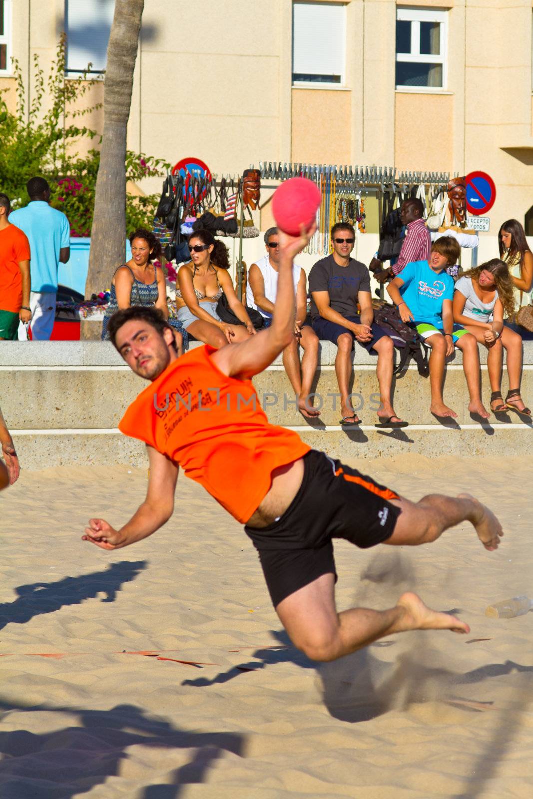 CADIZ, SPAIN - JULY 19: Unidentified players compete in a match between Los Negritos and Autoescuela Barquin in the 19th league of beach handball of Cadiz on July 19, 2011 in Cadiz, Spain