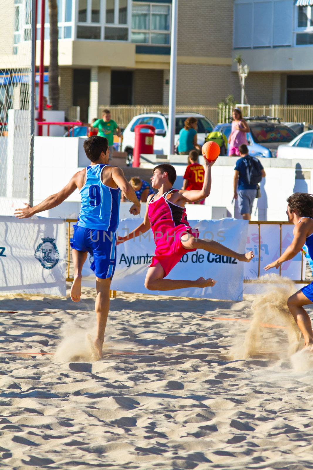 CADIZ, SPAIN - JULY 19: Unidentified players compete in a match between Zonabalonmano.com and CadizSur Seguros BMPY in the 19th league of beach handball of Cadiz on July 19, 2011 in Cadiz, Spain