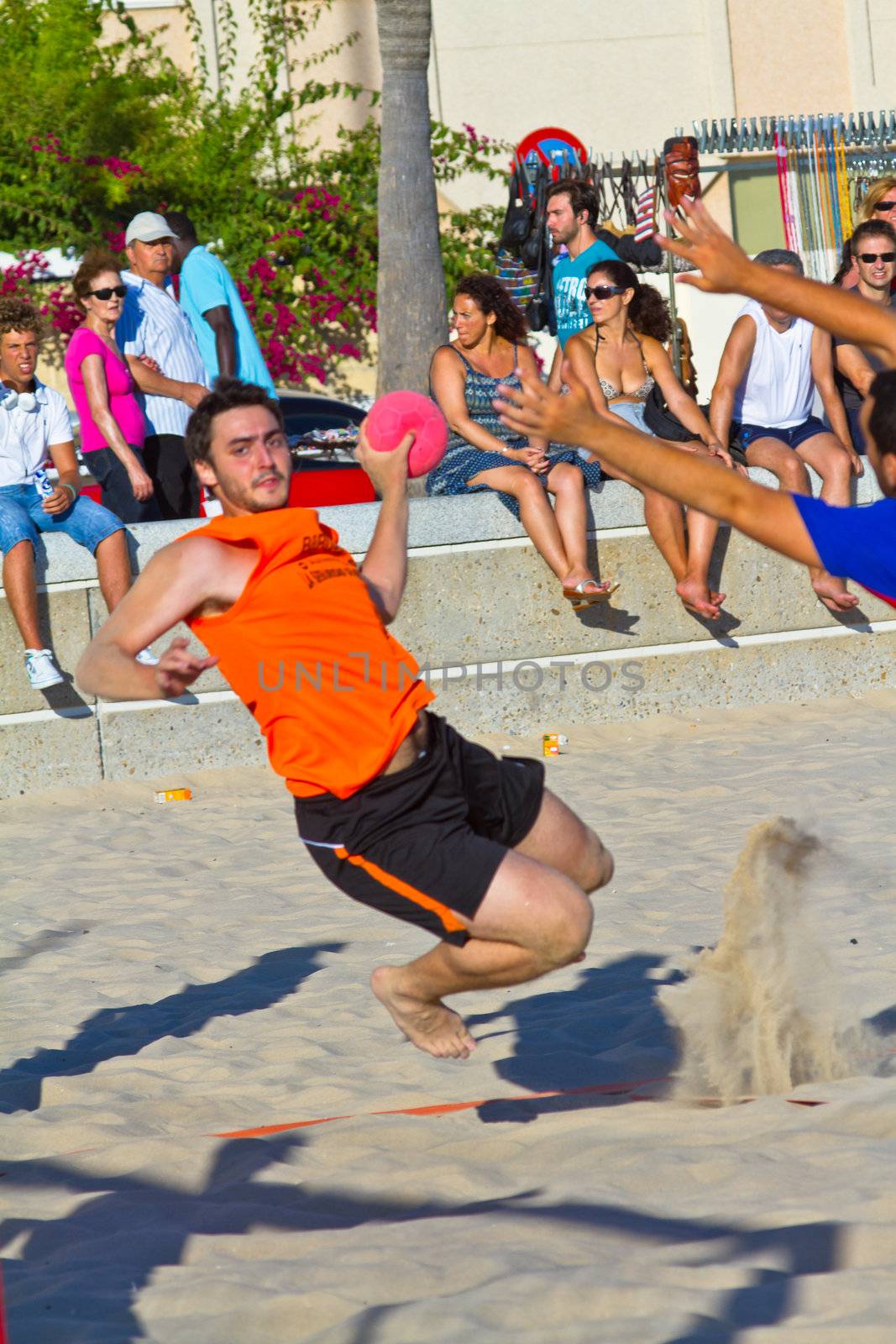 CADIZ, SPAIN - JULY 19: Unidentified players compete in a match between Los Negritos and Autoescuela Barquin in the 19th league of beach handball of Cadiz on July 19, 2011 in Cadiz, Spain
