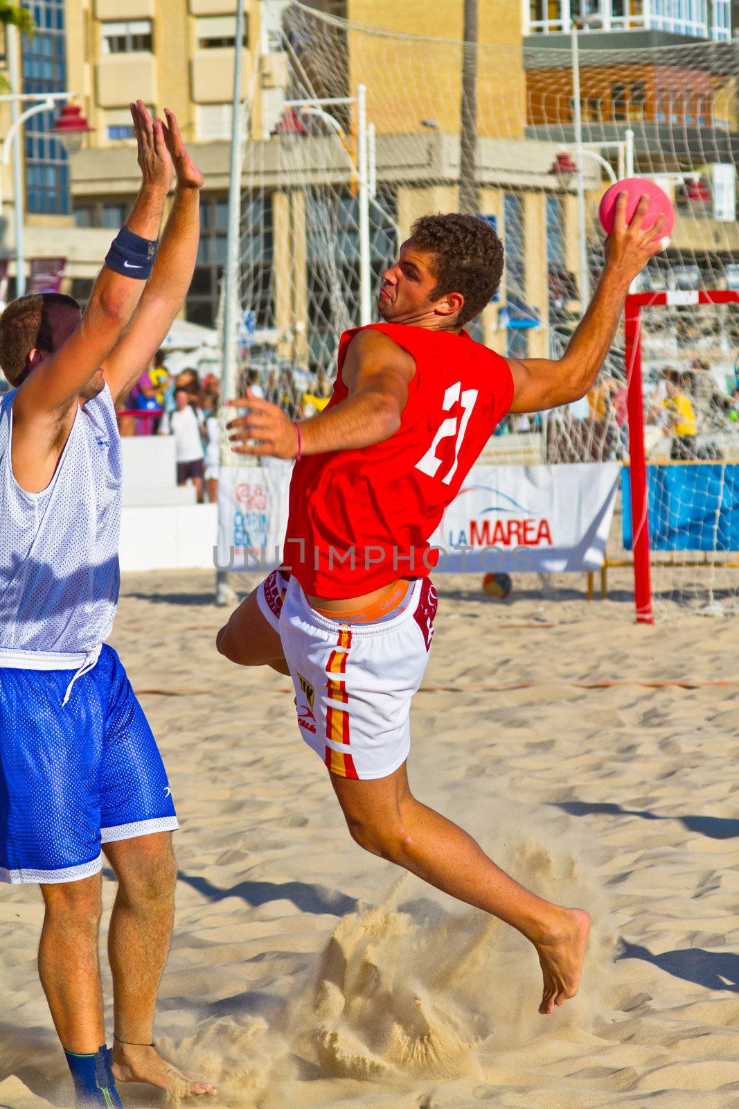 CADIZ, SPAIN - JULY 19: Unidentified players compete in a match between Los Negritos and Autoescuela Barquin in the 19th league of beach handball of Cadiz on July 19, 2011 in Cadiz, Spain