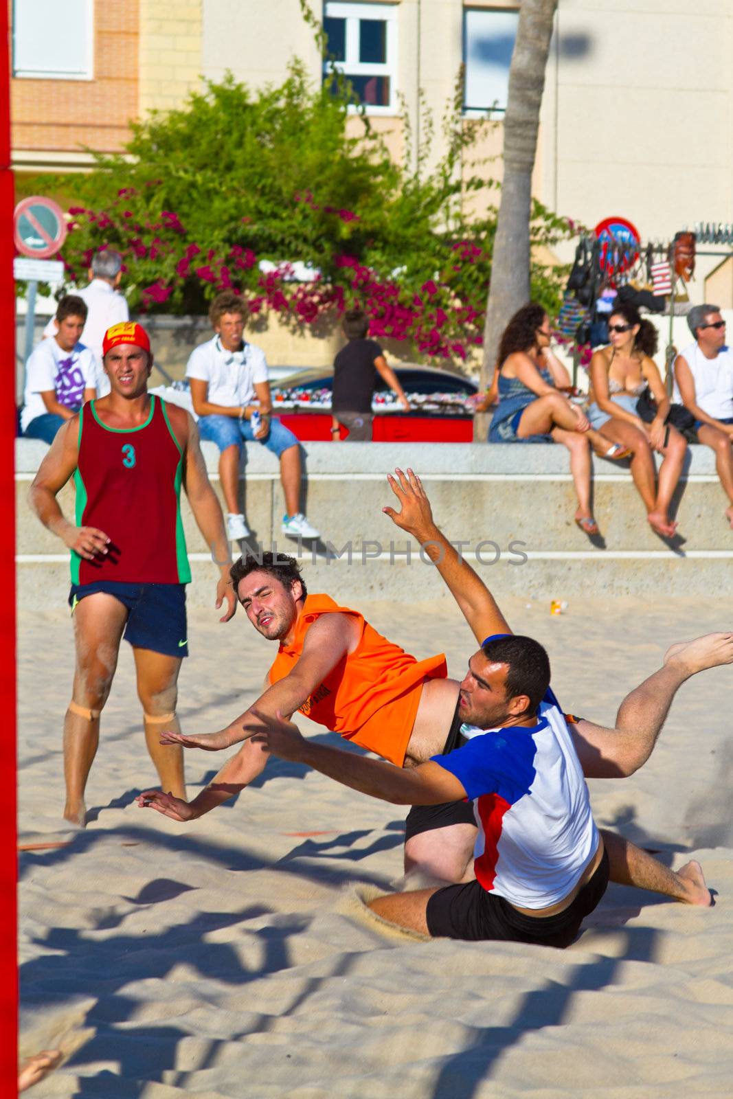CADIZ, SPAIN - JULY 19: Unidentified players compete in a match between Los Negritos and Autoescuela Barquin in the 19th league of beach handball of Cadiz on July 19, 2011 in Cadiz, Spain
