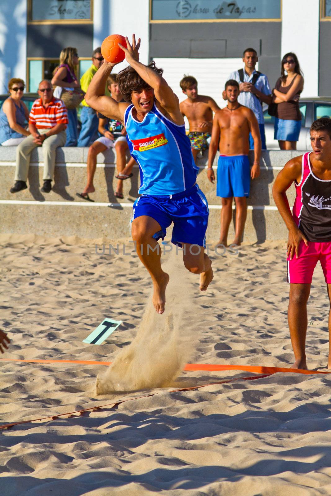 CADIZ, SPAIN - JULY 19: Unidentified players compete in a match between Zonabalonmano.com and CadizSur Seguros BMPY in the 19th league of beach handball of Cadiz on July 19, 2011 in Cadiz, Spain