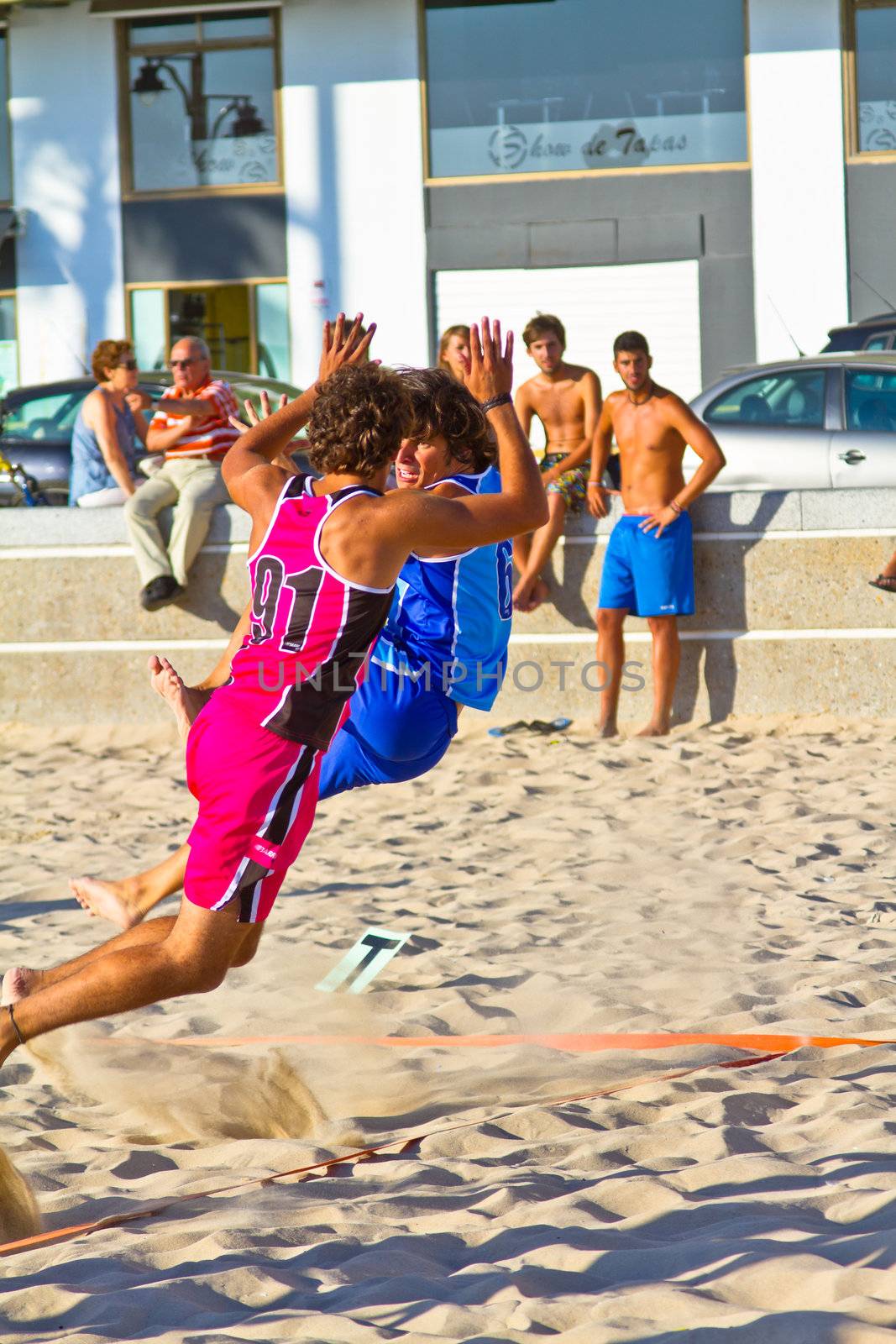 CADIZ, SPAIN - JULY 19: Unidentified players compete in a match between Zonabalonmano.com and CadizSur Seguros BMPY in the 19th league of beach handball of Cadiz on July 19, 2011 in Cadiz, Spain