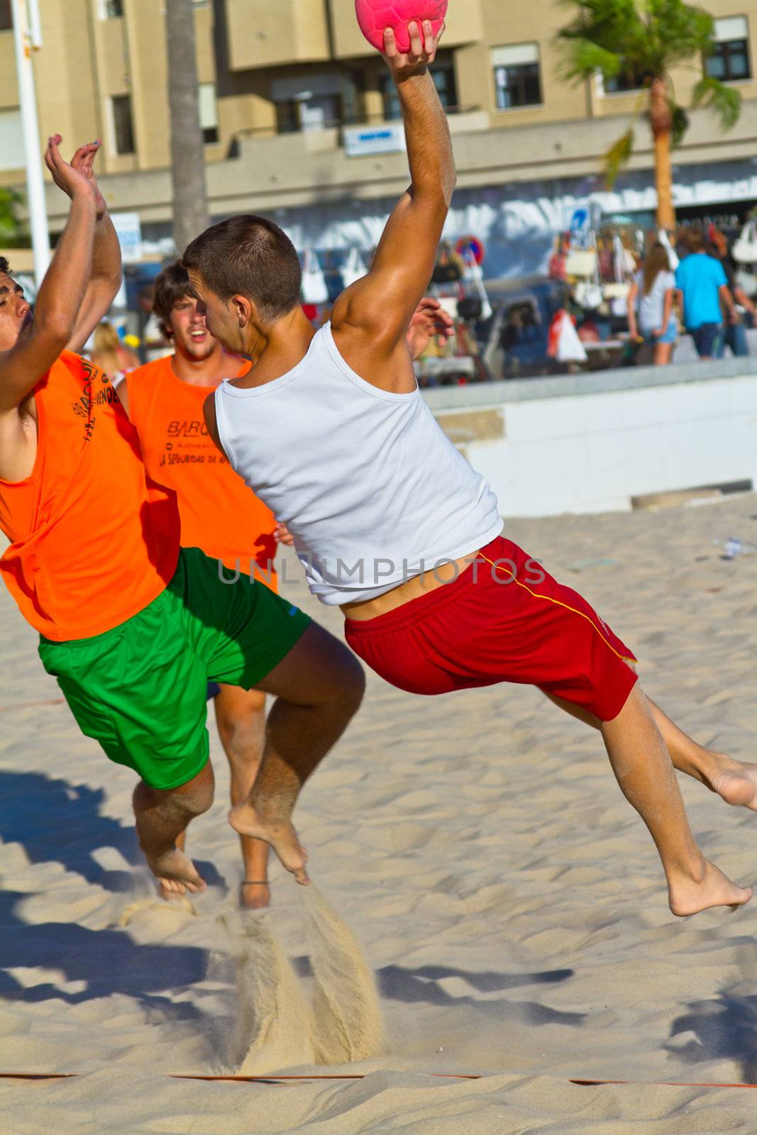 CADIZ, SPAIN - JULY 19: Unidentified players compete in a match between Los Negritos and Autoescuela Barquin in the 19th league of beach handball of Cadiz on July 19, 2011 in Cadiz, Spain