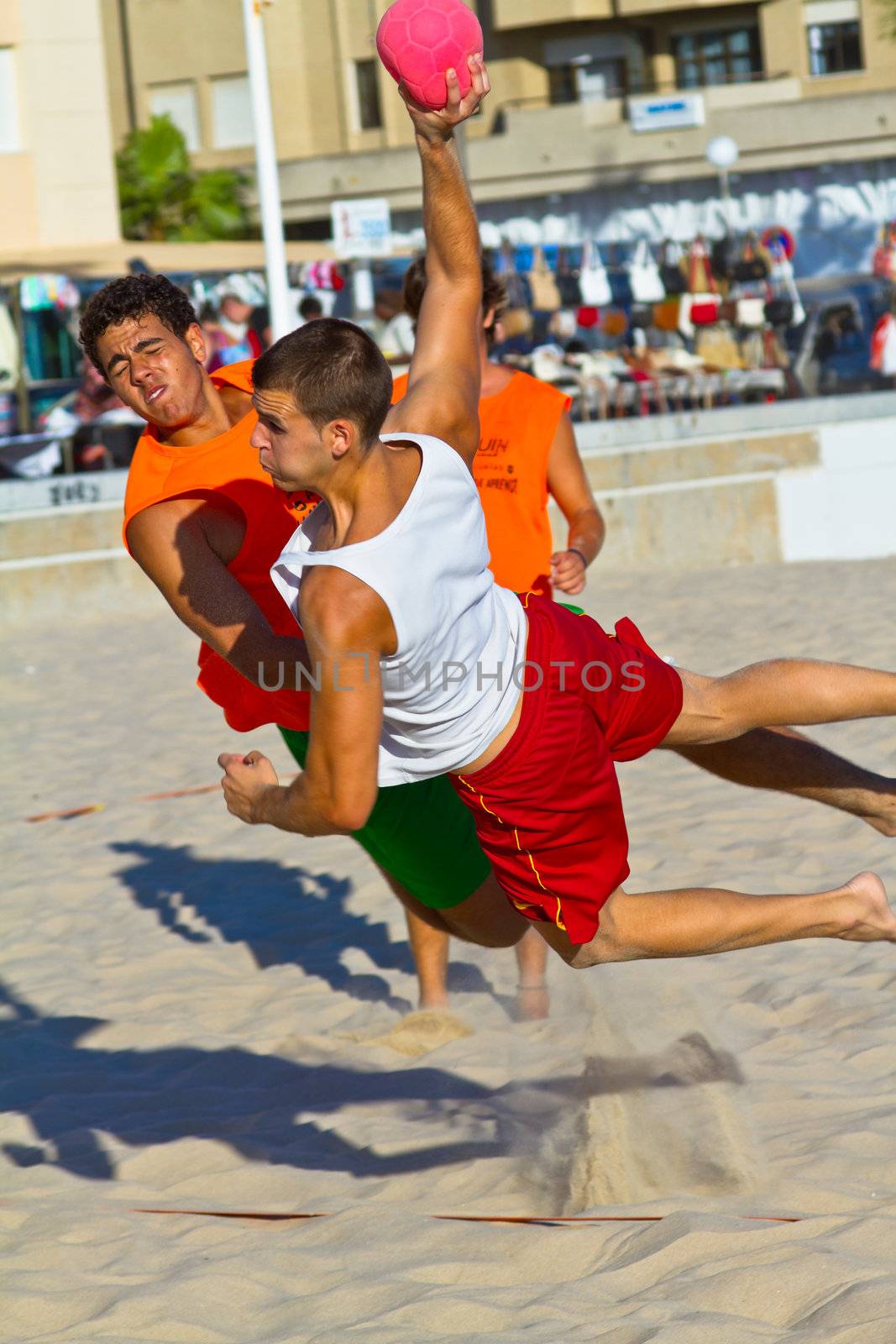 CADIZ, SPAIN - JULY 19: Unidentified players compete in a match between Los Negritos and Autoescuela Barquin in the 19th league of beach handball of Cadiz on July 19, 2011 in Cadiz, Spain