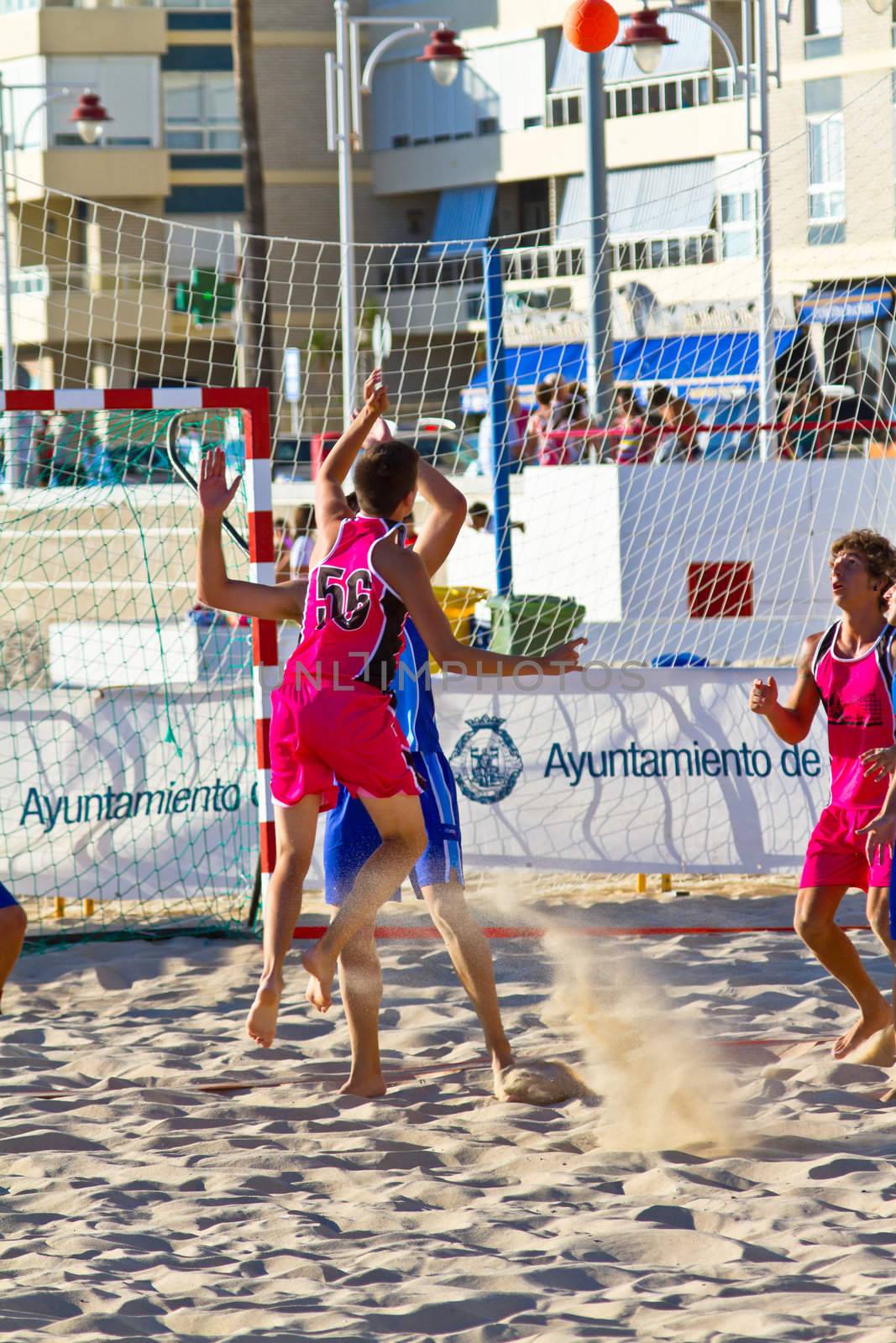 CADIZ, SPAIN - JULY 19: Unidentified players compete in a match between Zonabalonmano.com and CadizSur Seguros BMPY in the 19th league of beach handball of Cadiz on July 19, 2011 in Cadiz, Spain