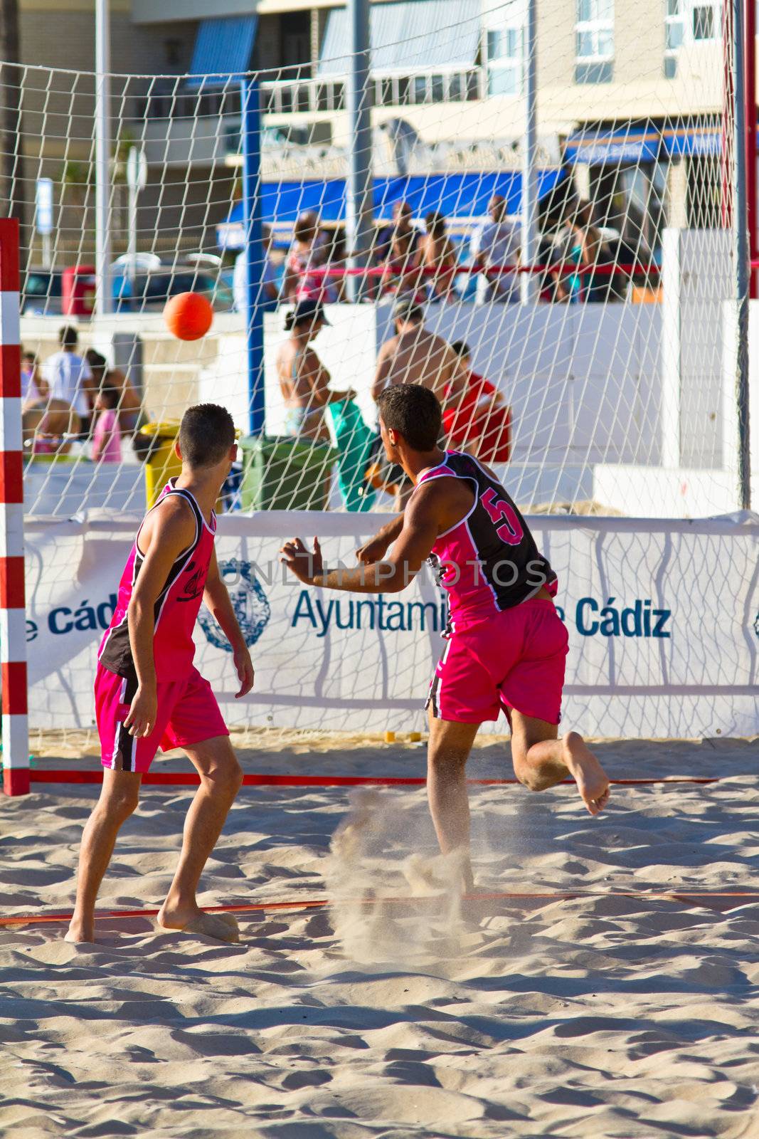 CADIZ, SPAIN - JULY 19: Unidentified players compete in a match between Zonabalonmano.com and CadizSur Seguros BMPY in the 19th league of beach handball of Cadiz on July 19, 2011 in Cadiz, Spain