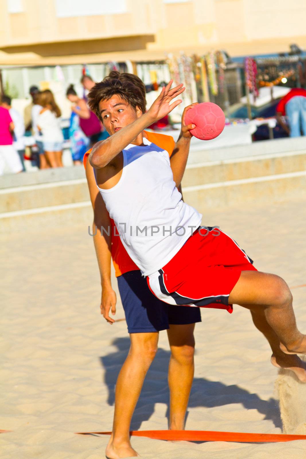 CADIZ, SPAIN - JULY 19: Unidentified players compete in a match between Los Negritos and Autoescuela Barquin in the 19th league of beach handball of Cadiz on July 19, 2011 in Cadiz, Spain