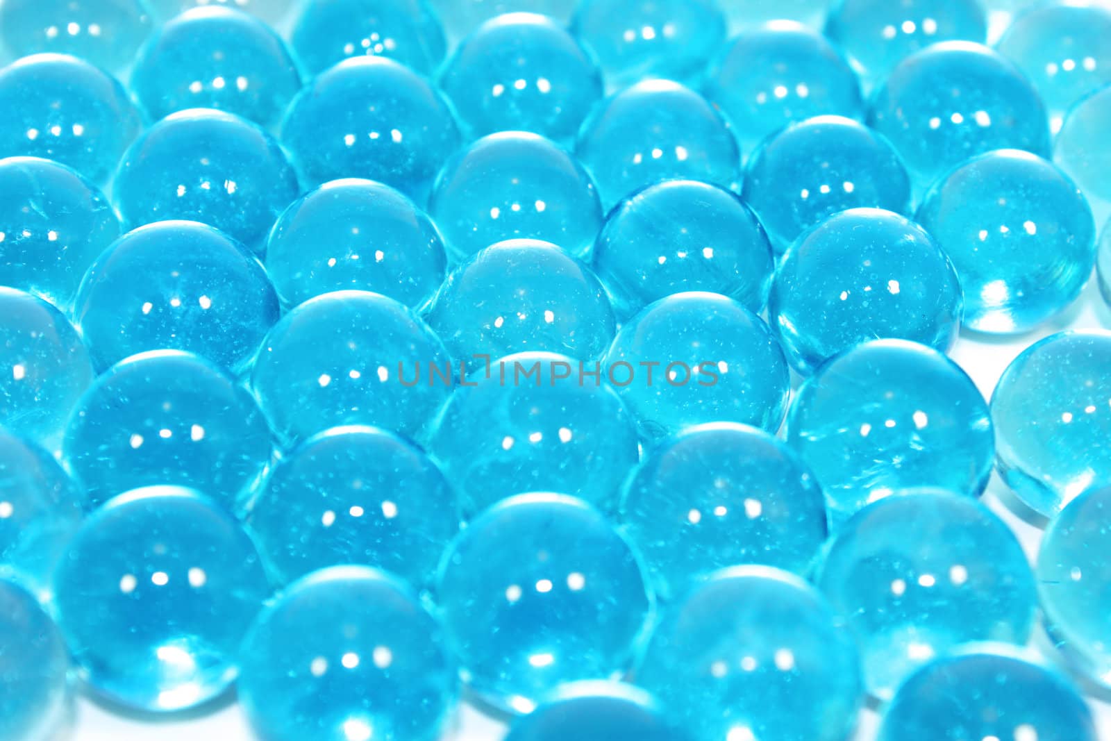A background of colourful glass marbles. Blue version