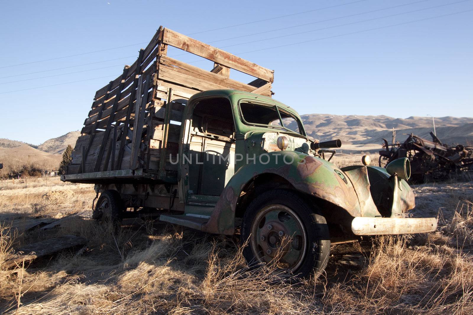 An old abandoned vintage delivery truck van in a field by jeremywhat