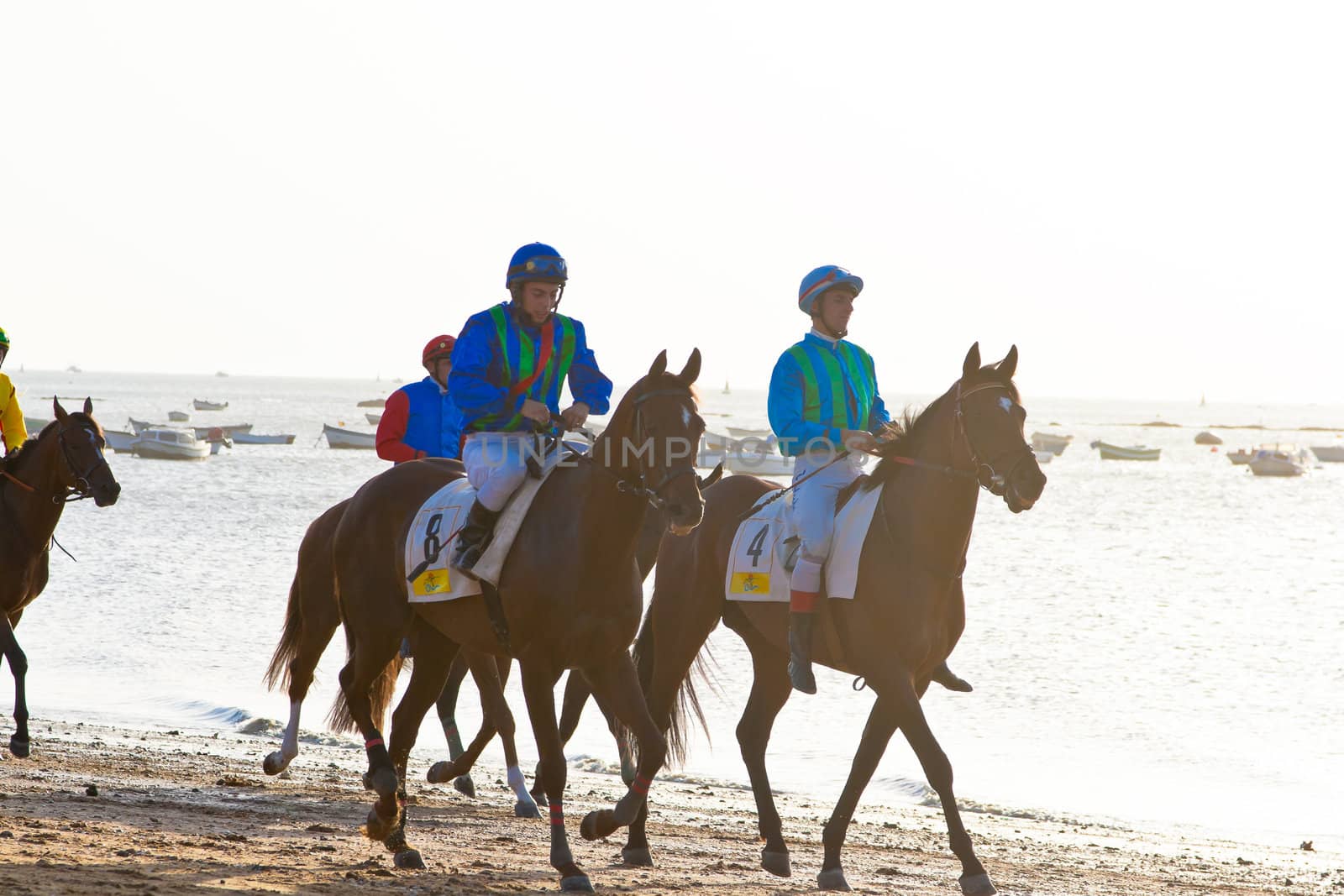 SANLUCAR DE BARRAMEDA, CADIZ, SPAIN - AUGUST 10: Unidentified riders at the start of race horses on Sanlucar de Barrameda beach on August 10, 2011 in Sanlucar de Barrameda, Cadiz, Spain.