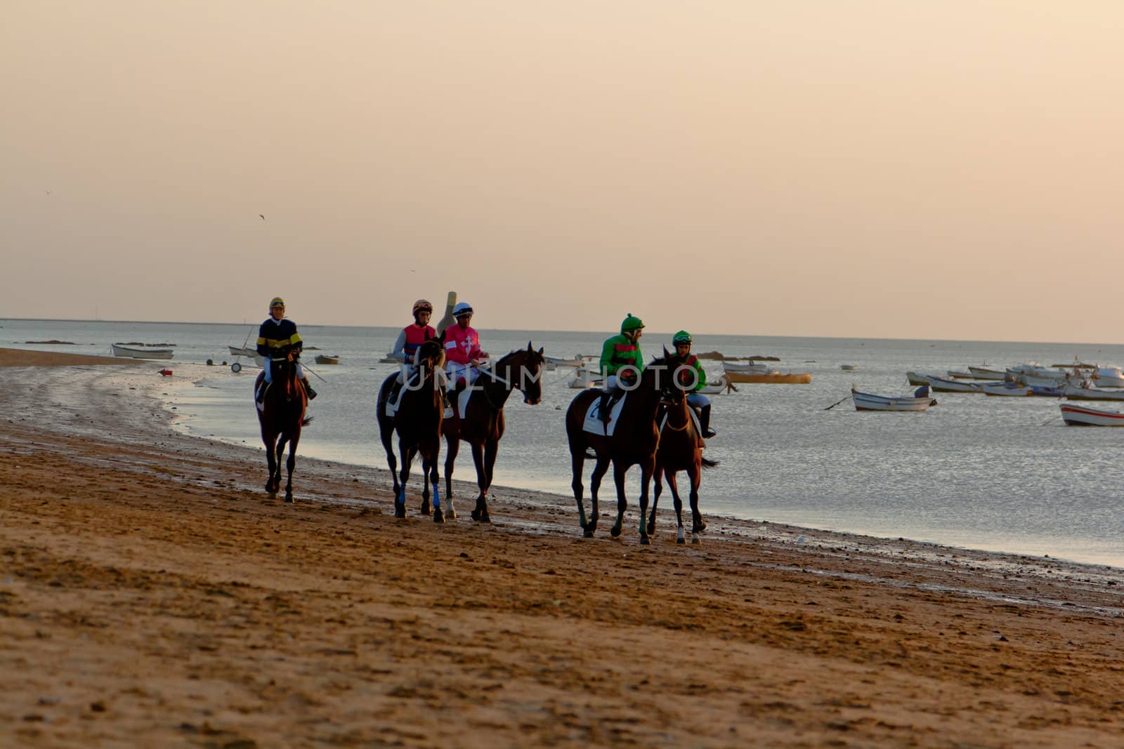 SANLUCAR DE BARRAMEDA, CADIZ, SPAIN - AUGUST 10: Unidentified riders at the start of race horses on Sanlucar de Barrameda beach on August 10, 2011 in Sanlucar de Barrameda, Cadiz, Spain.