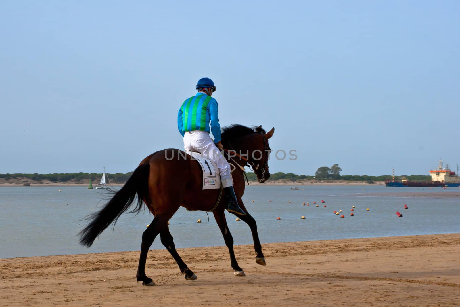 SANLUCAR DE BARRAMEDA, CADIZ, SPAIN - AUGUST 10: Unidentified rider at the start of race horses on Sanlucar de Barrameda beach on August 10, 2011 in Sanlucar de Barrameda, Cadiz, Spain.
