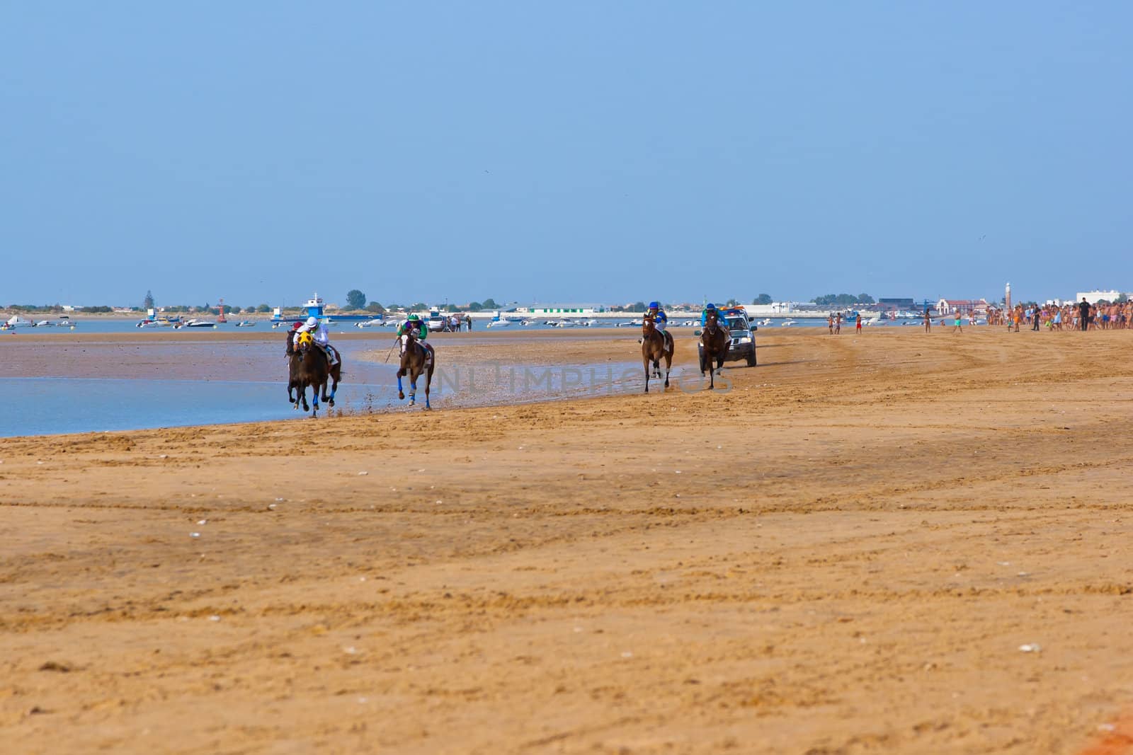 SANLUCAR DE BARRAMEDA, CADIZ, SPAIN - AUGUST 10: Unidentified rider at the start of race horses on Sanlucar de Barrameda beach on August 10, 2011 in Sanlucar de Barrameda, Cadiz, Spain.