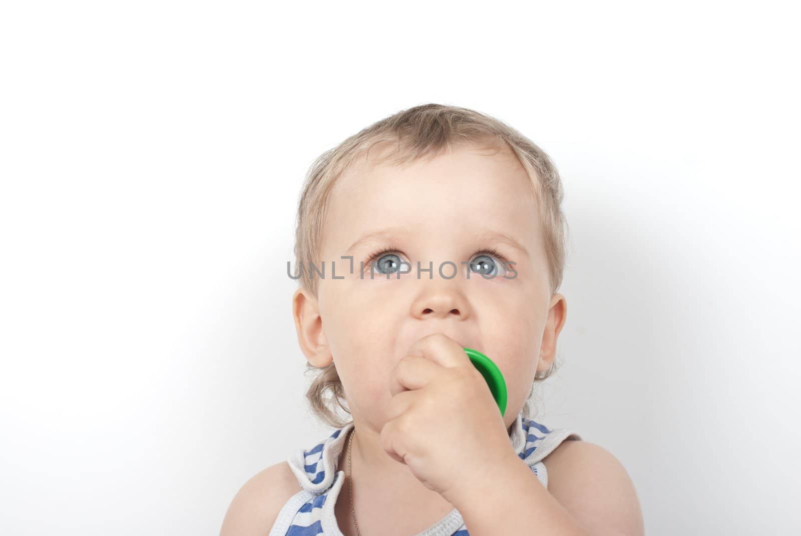 Small baby boy with a toy pyramid isolated on white