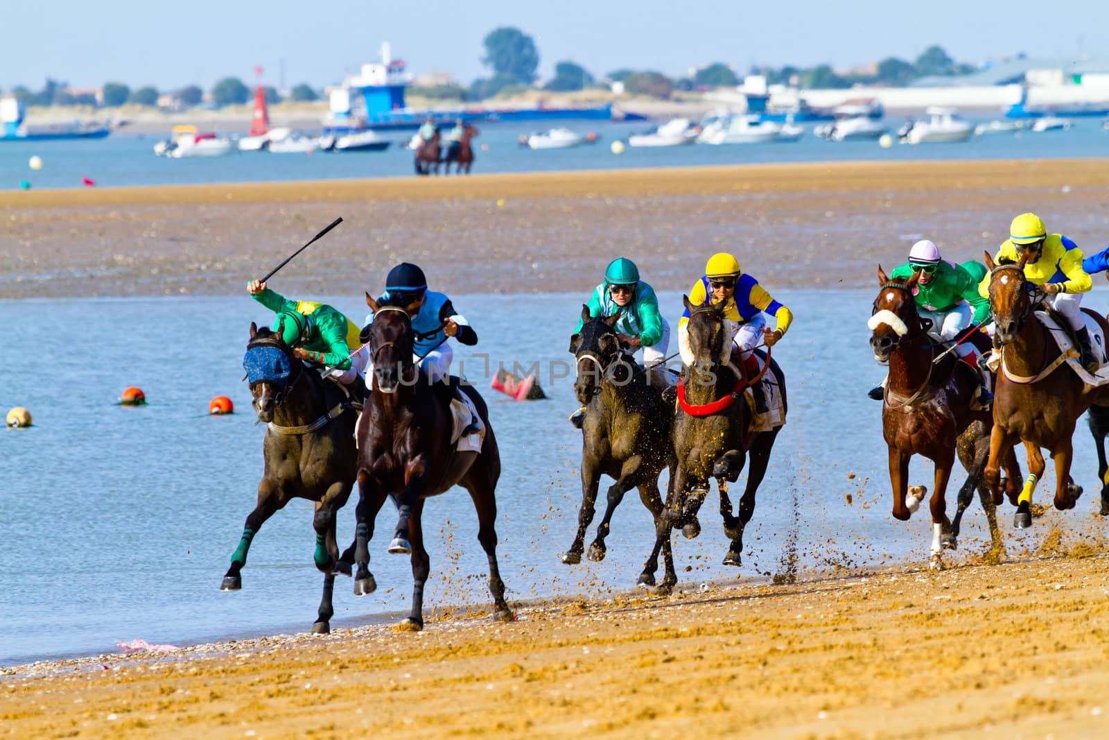 SANLUCAR DE BARRAMEDA, CADIZ, SPAIN - AUGUST 10: Unidentified riders at the start of race horses on Sanlucar de Barrameda beach on August 10, 2011 in Sanlucar de Barrameda, Cadiz, Spain.