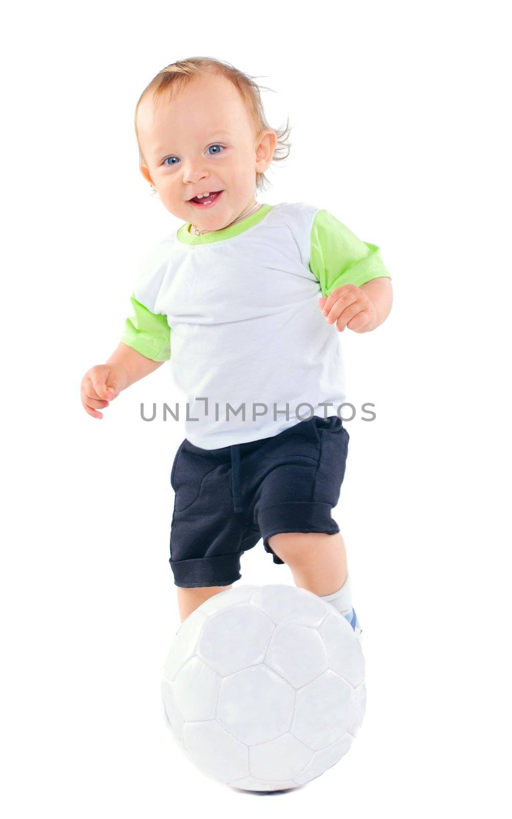 Cute 1 years old boy in sports form with a soccer ball in the studio