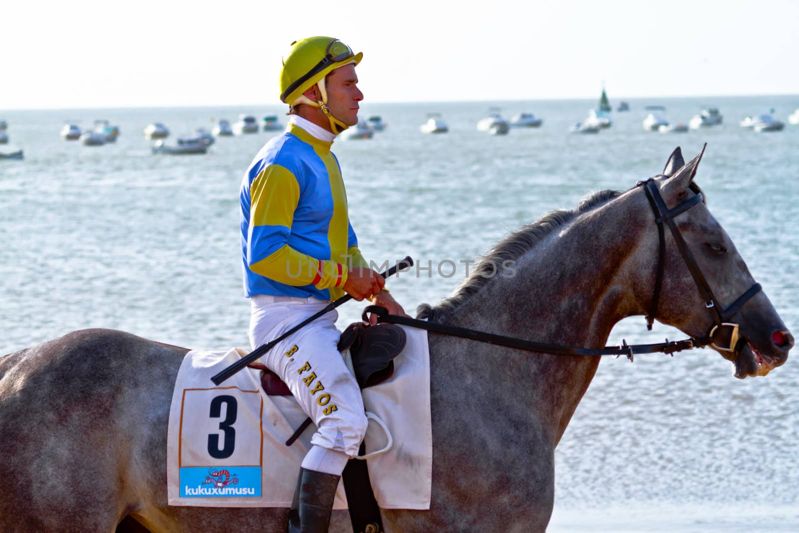 SANLUCAR DE BARRAMEDA, CADIZ, SPAIN - AUGUST 10: Unidentified rider at the start of race horses on Sanlucar de Barrameda beach on August 10, 2011 in Sanlucar de Barrameda, Cadiz, Spain.