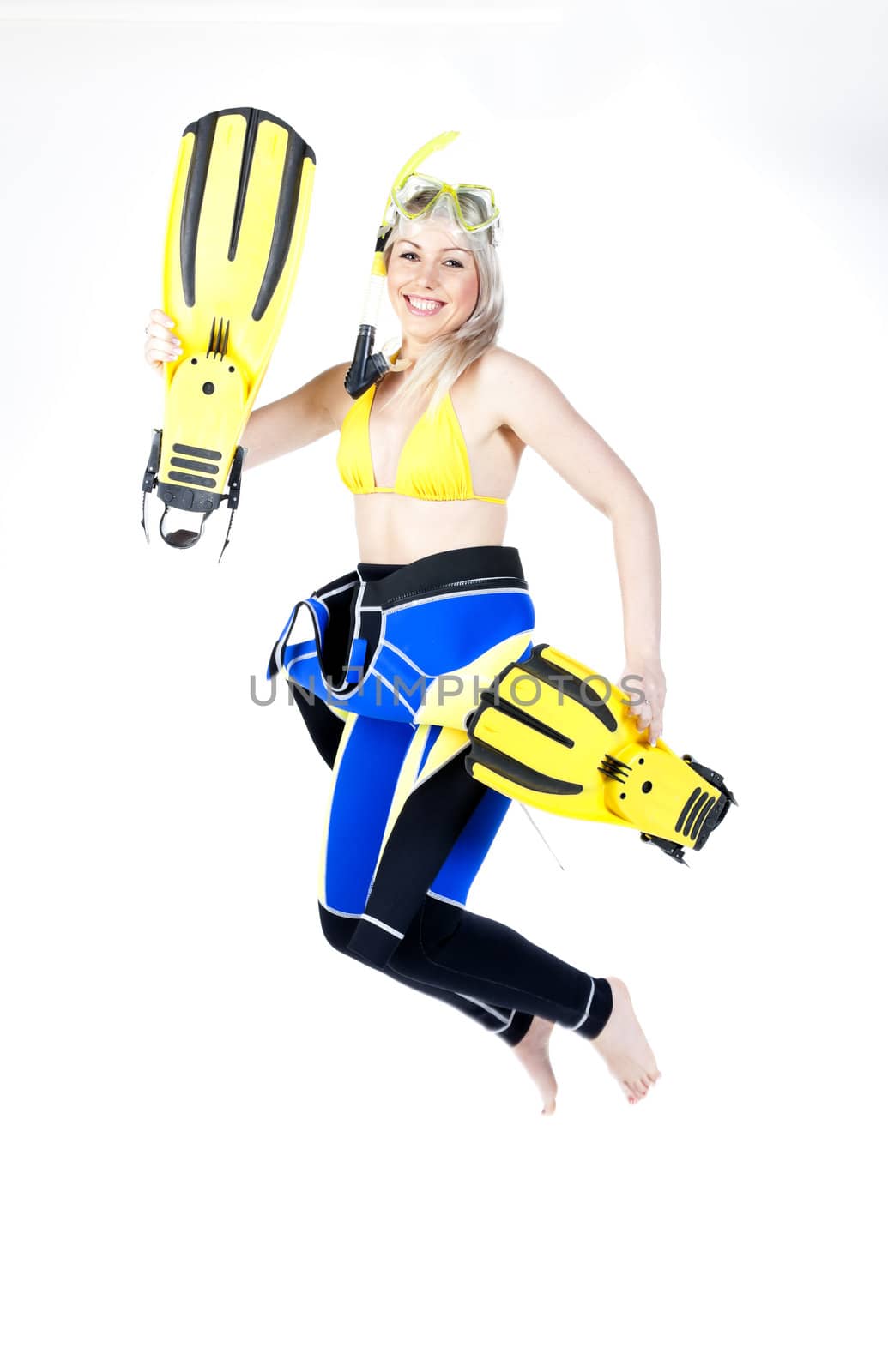 standing young woman wearing neoprene with snorkeling equipment