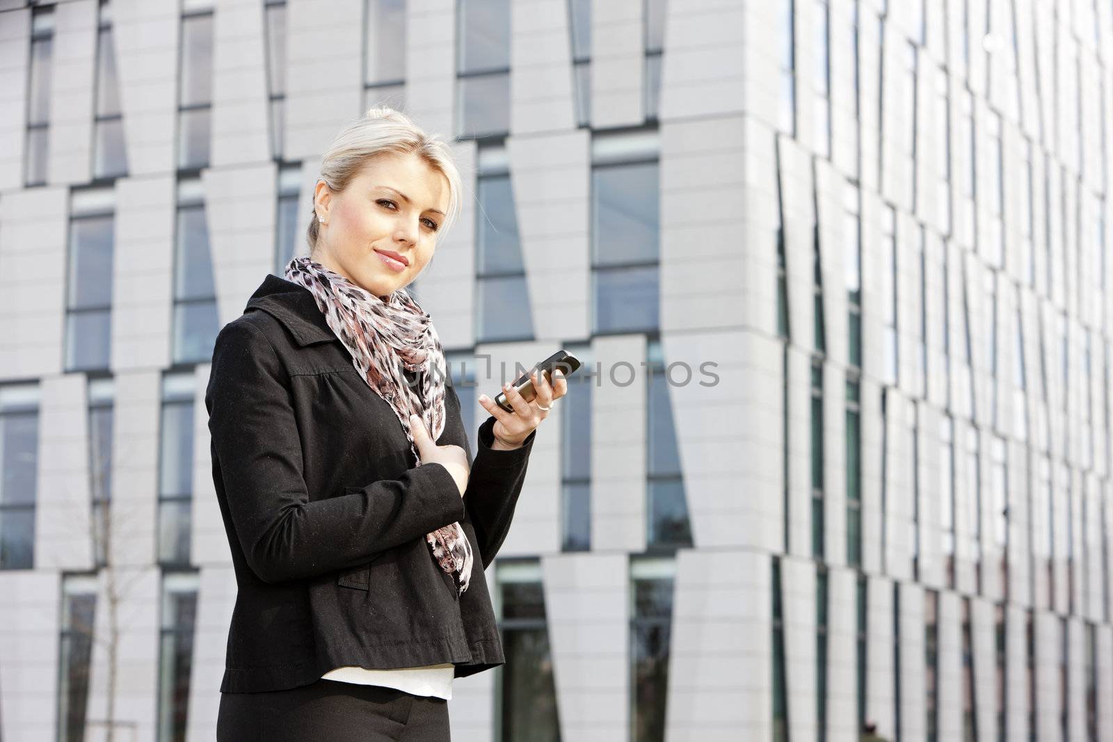 portrait of young businesswoman with a mobile by phbcz