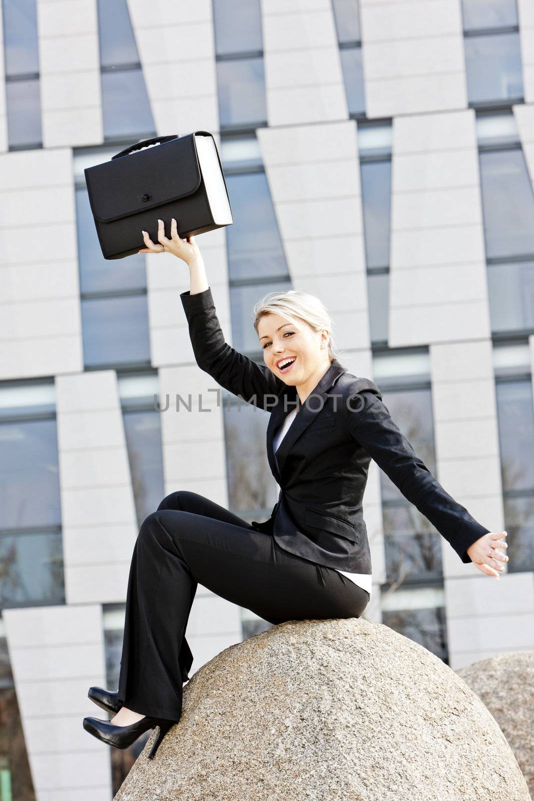 sitting young businesswoman with a briefcase