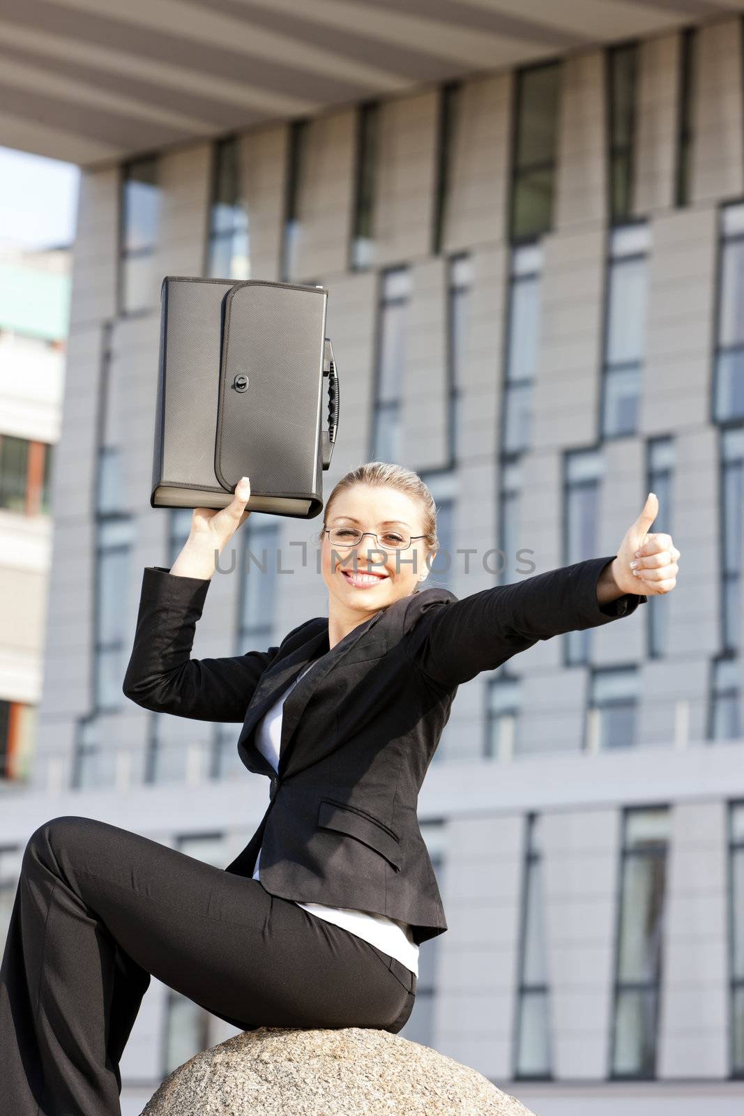 sitting young businesswoman with a briefcase
