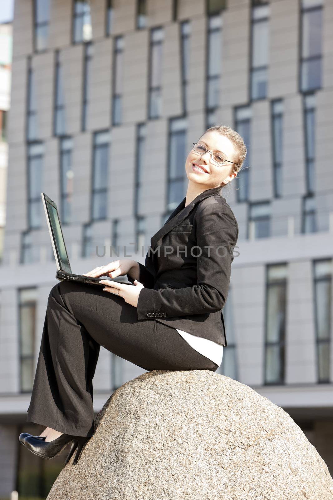 sitting young businesswoman with a notebook