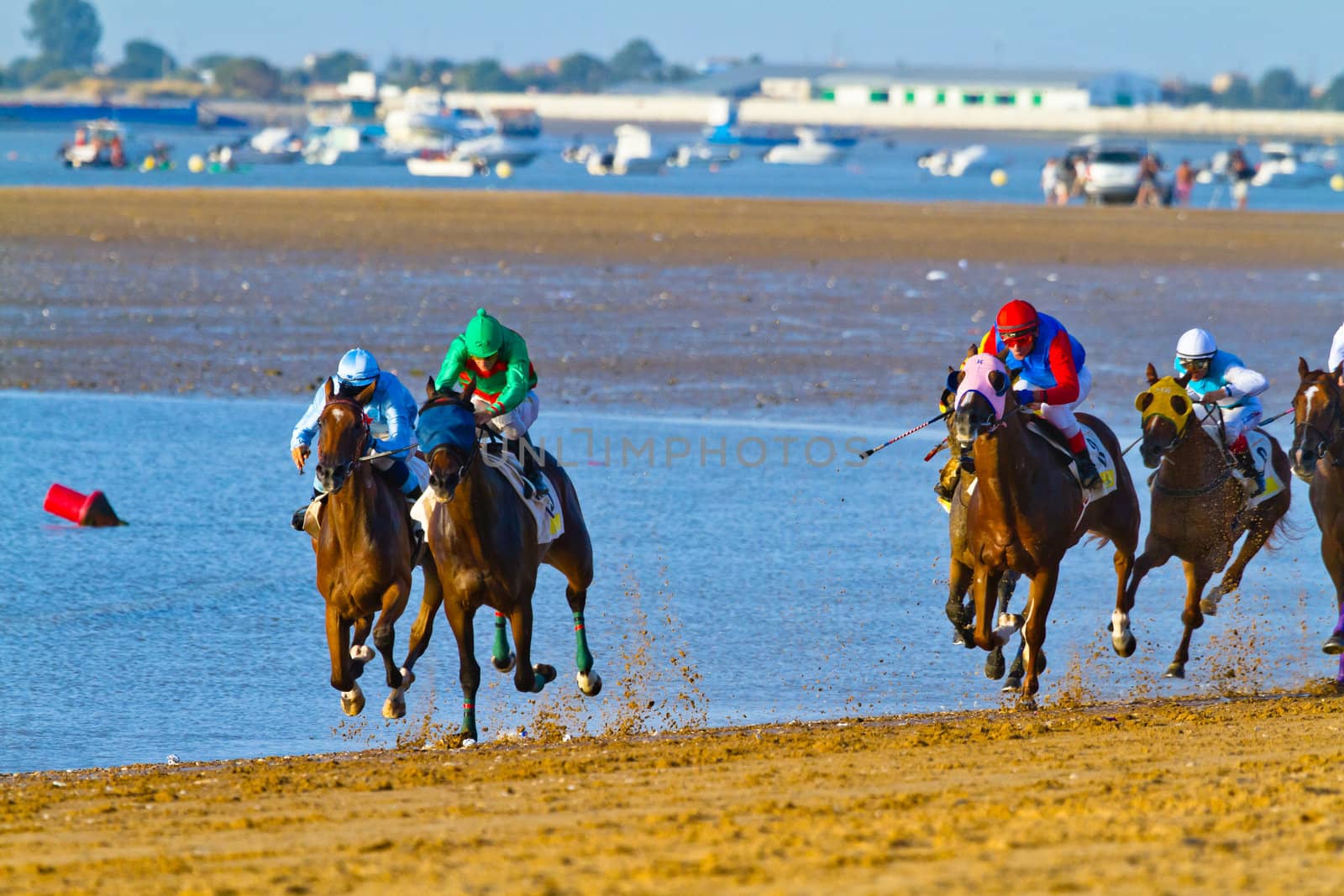 SANLUCAR DE BARRAMEDA, CADIZ, SPAIN - AUGUST 10: Unidentified riders at the start of race horses on Sanlucar de Barrameda beach on August 10, 2011 in Sanlucar de Barrameda, Cadiz, Spain.