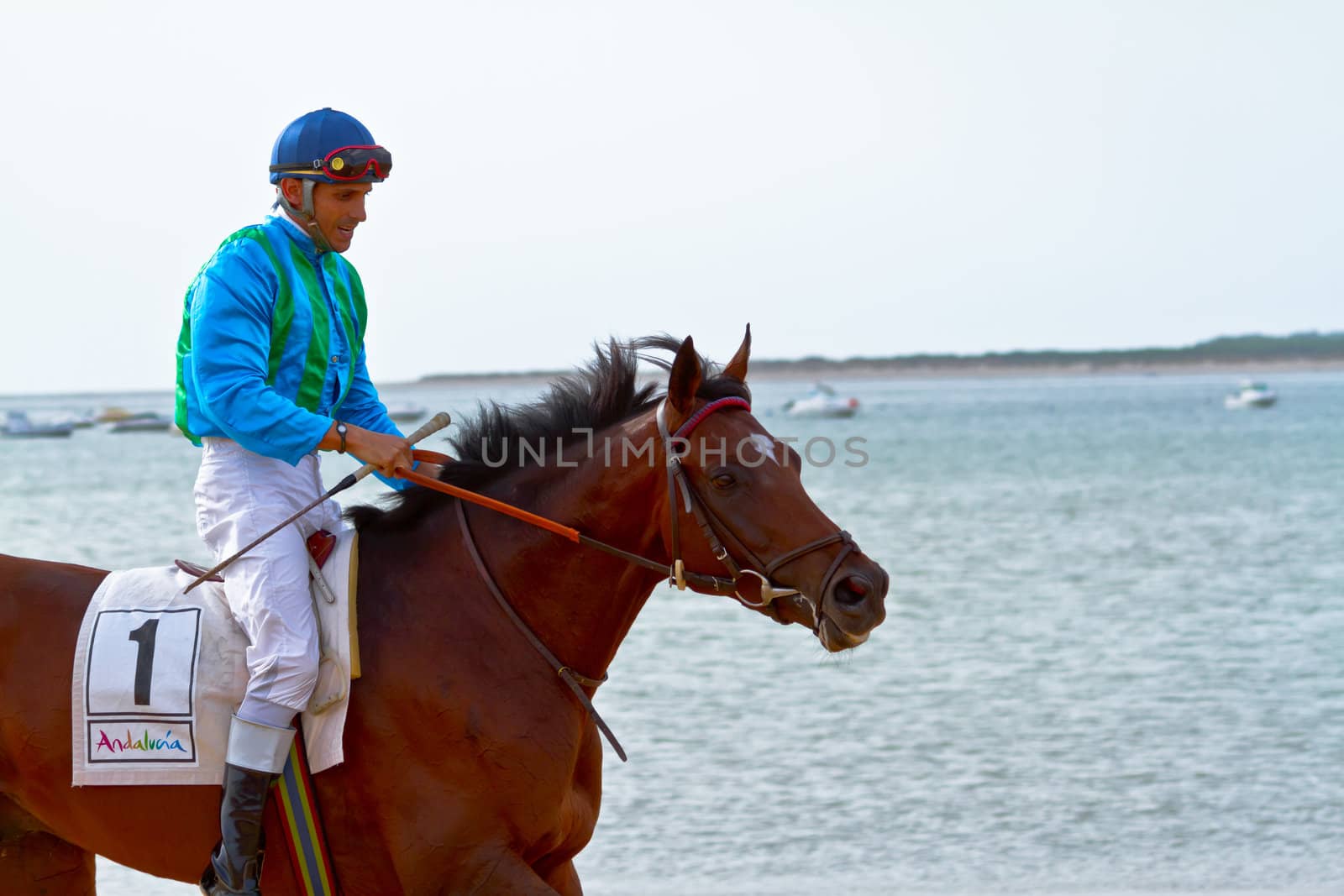 SANLUCAR DE BARRAMEDA, CADIZ, SPAIN - AUGUST 11: Unidentified rider at the start of race horses on Sanlucar de Barrameda beach on August 11, 2011 in Sanlucar de Barrameda, Cadiz, Spain.