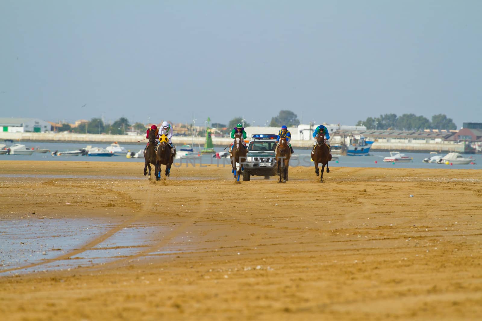 SANLUCAR DE BARRAMEDA, CADIZ, SPAIN - AUGUST 11: Unidentified rider at the start of race horses on Sanlucar de Barrameda beach on August 11, 2011 in Sanlucar de Barrameda, Cadiz, Spain.