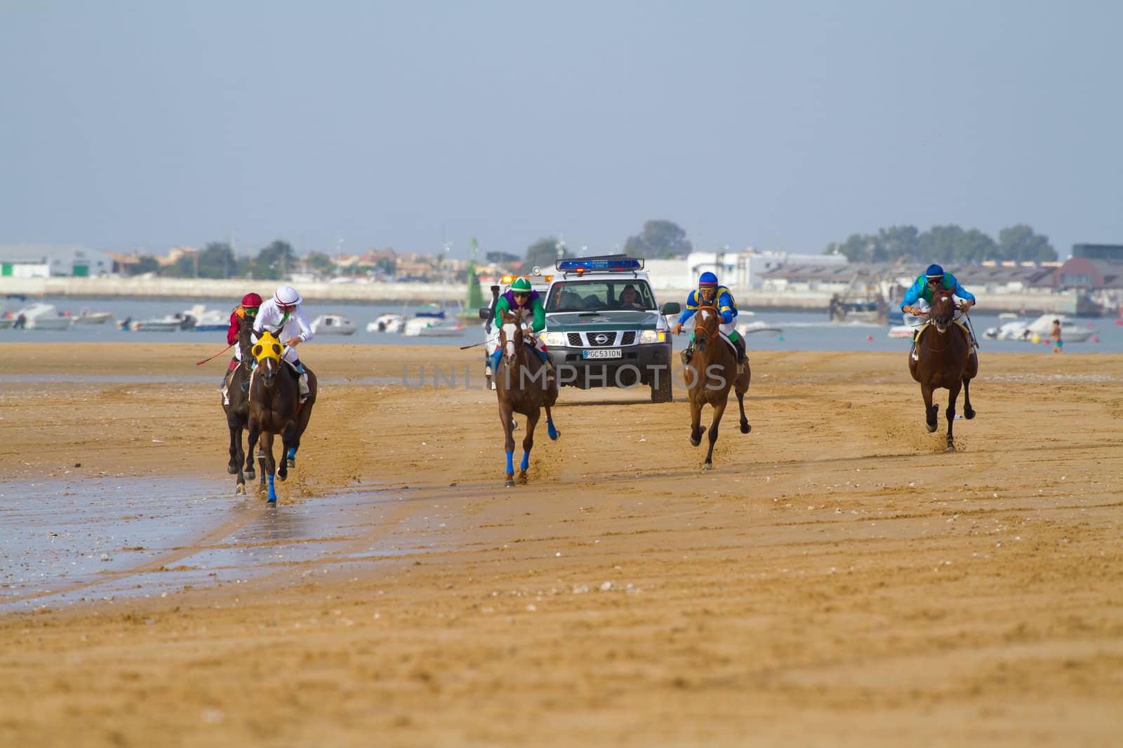 SANLUCAR DE BARRAMEDA, CADIZ, SPAIN - AUGUST 11: Unidentified rider at the start of race horses on Sanlucar de Barrameda beach on August 11, 2011 in Sanlucar de Barrameda, Cadiz, Spain.